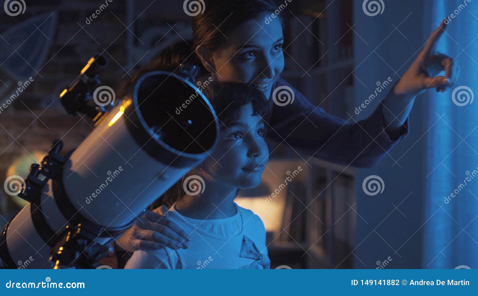 cute sisters watching the stars with a telescope