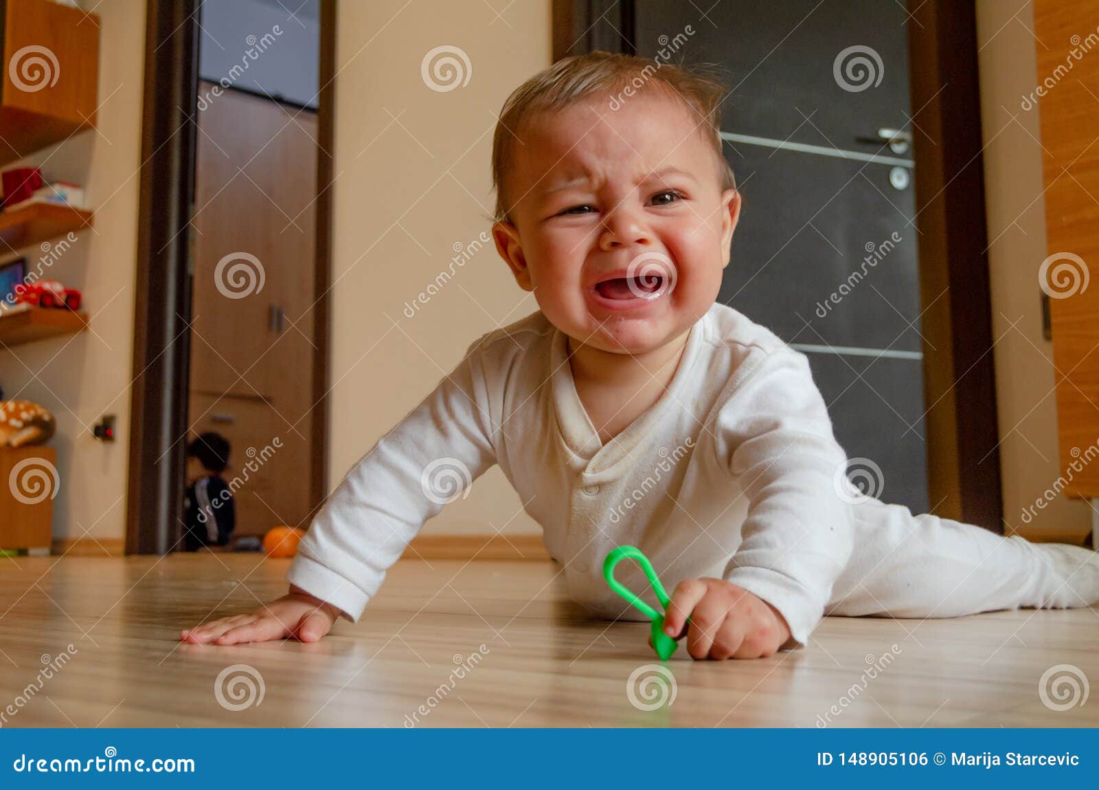 Cute Six Months Old Baby Boy Having Tummy Time On The Floor And