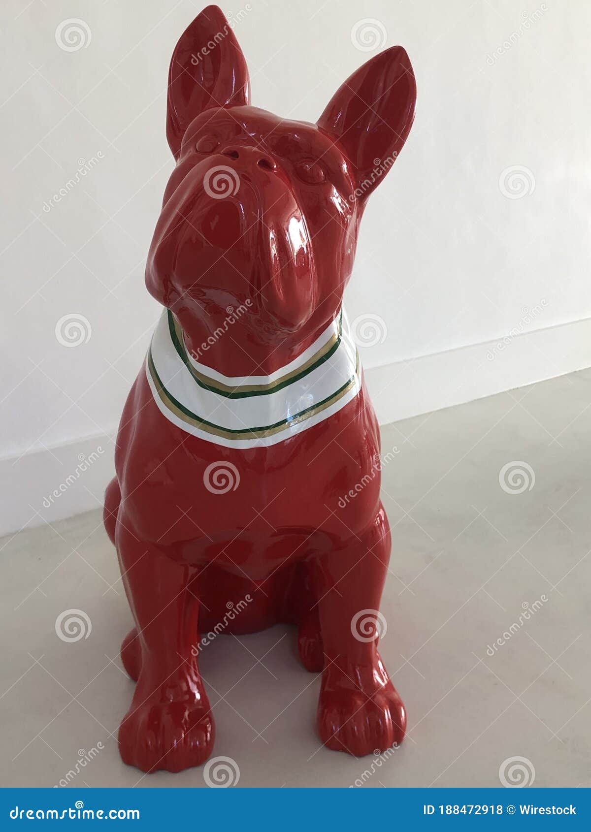 Cute Small, Red Statue of a Boxer Dog on a White Surface Stock Photo