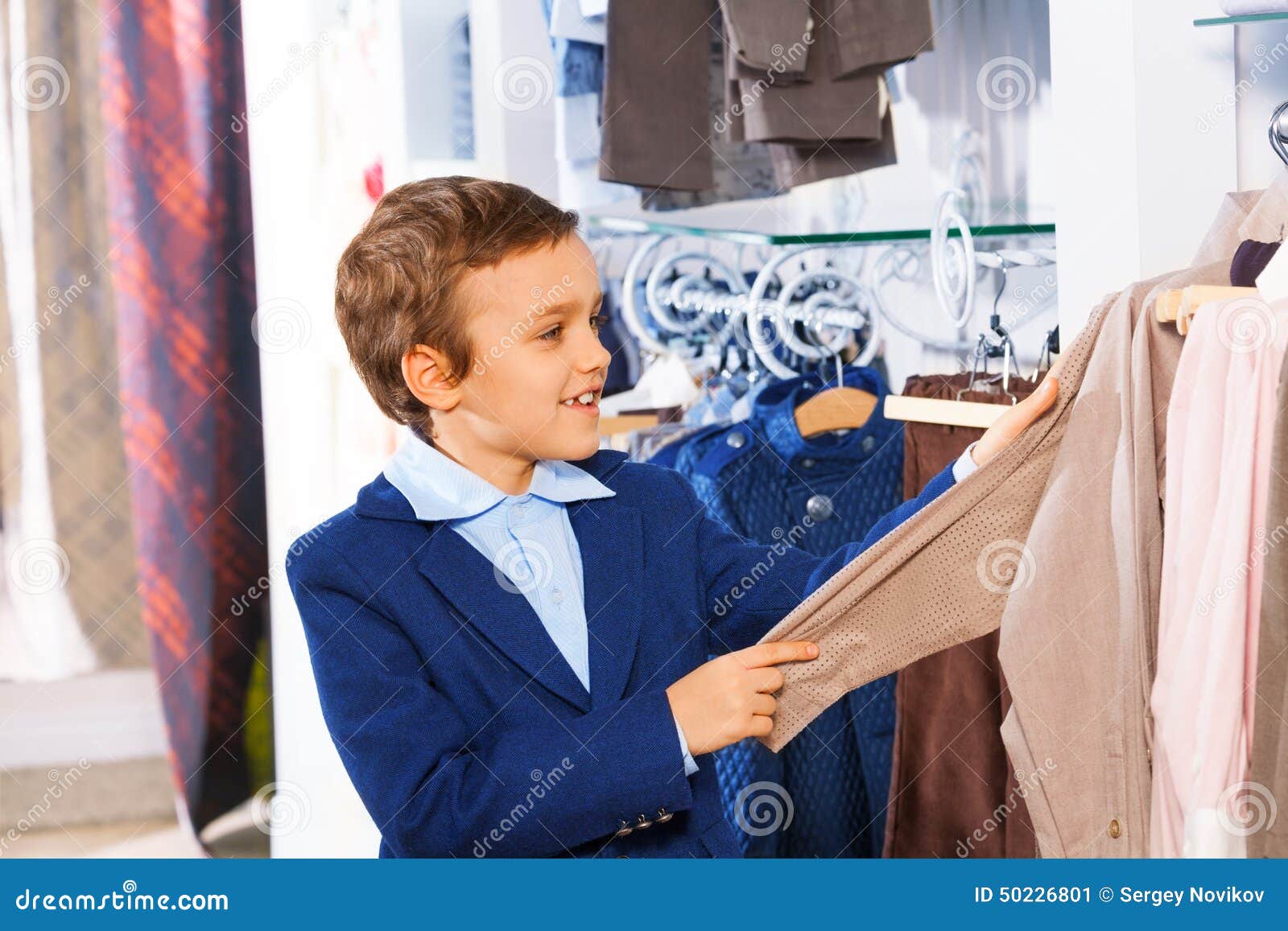 Cute Smiling Boy Stands Near Clothes and Choosing Stock Image - Image ...