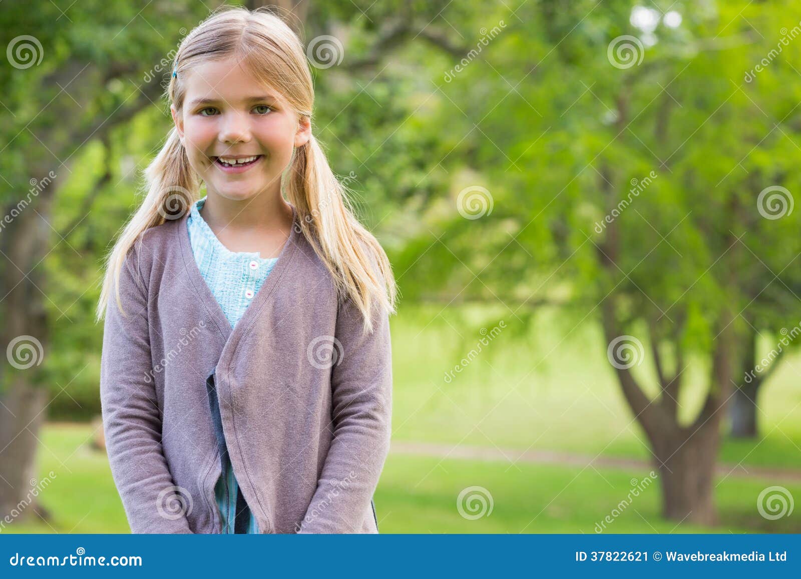 cute smiling girl standing at the park