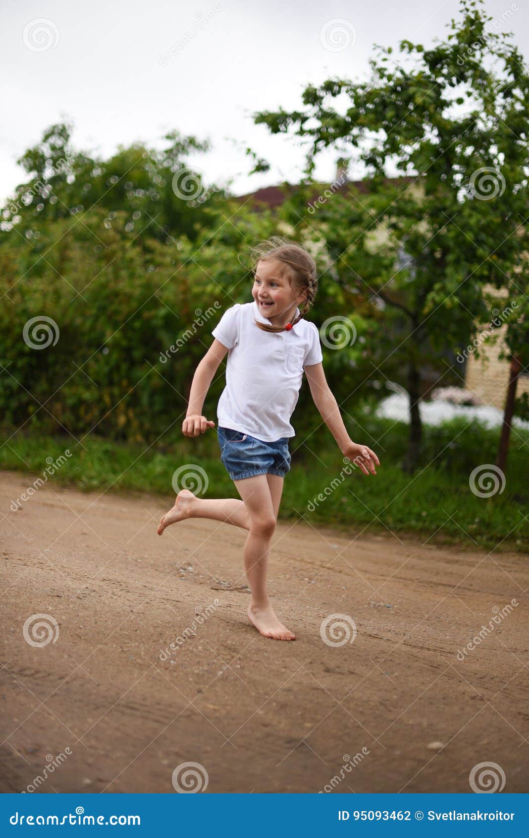 A Cute Smiling Little Girl Running Barefoot in a Countryside Landscape  Along a Country Path Stock Photo - Image of cute, field: 95093462