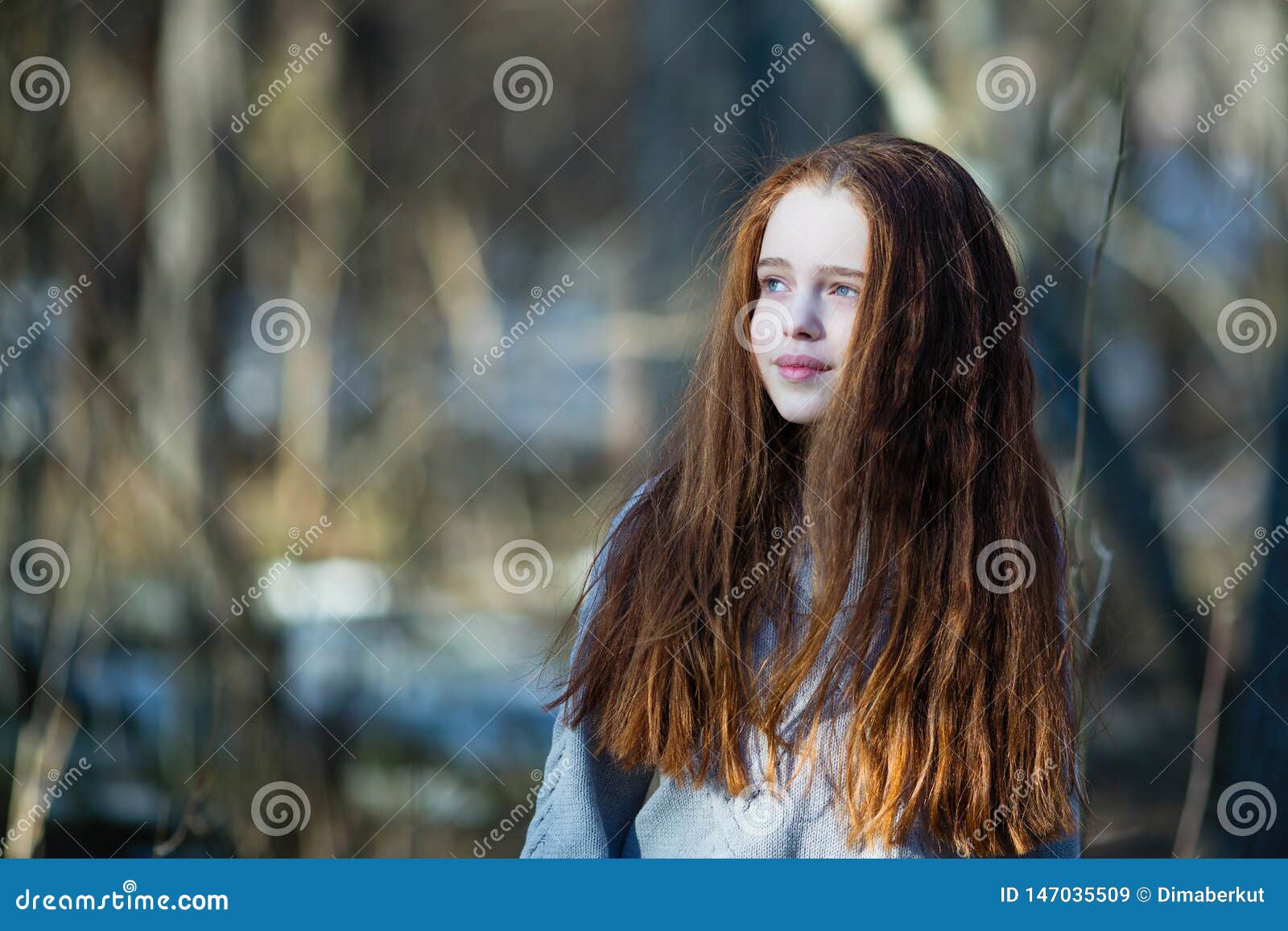 Cute Teen Girl With Fiery Red Hair Posing In The Pine Park