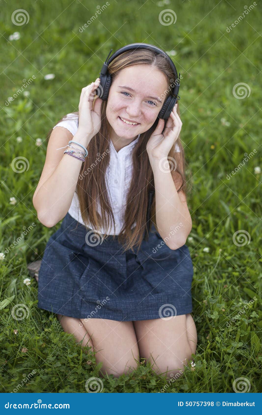 Cute Teen Girl In Headphones Enjoys The Music On The Green Grass In Park Love Of Music Stock