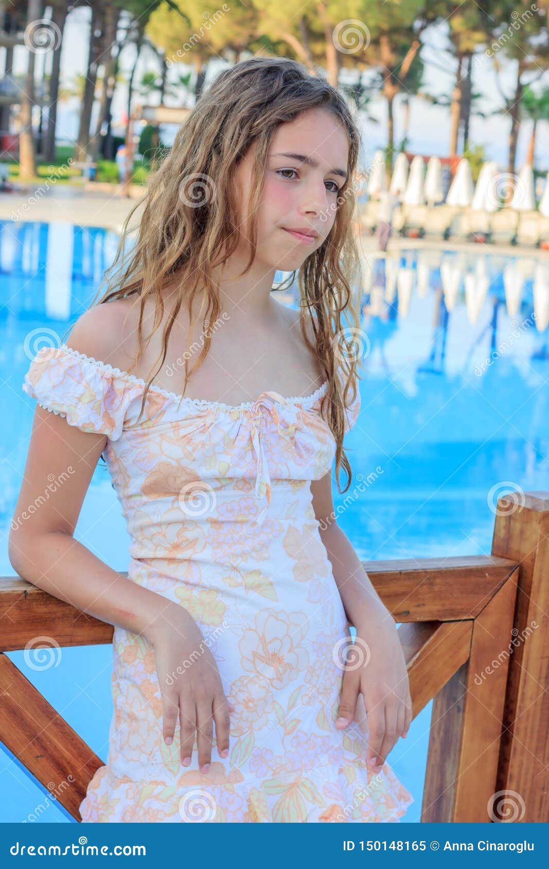 Cute Teen Girl in a Romantic Dress and with Long Hair is Standing on the  Bridge by the Pool Stock Image - Image of clean, beauty: 150148165