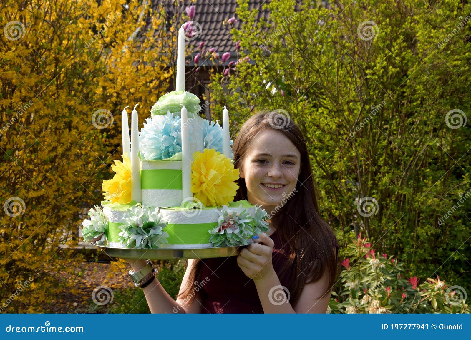 girl brings birthday cake made of toilet paper