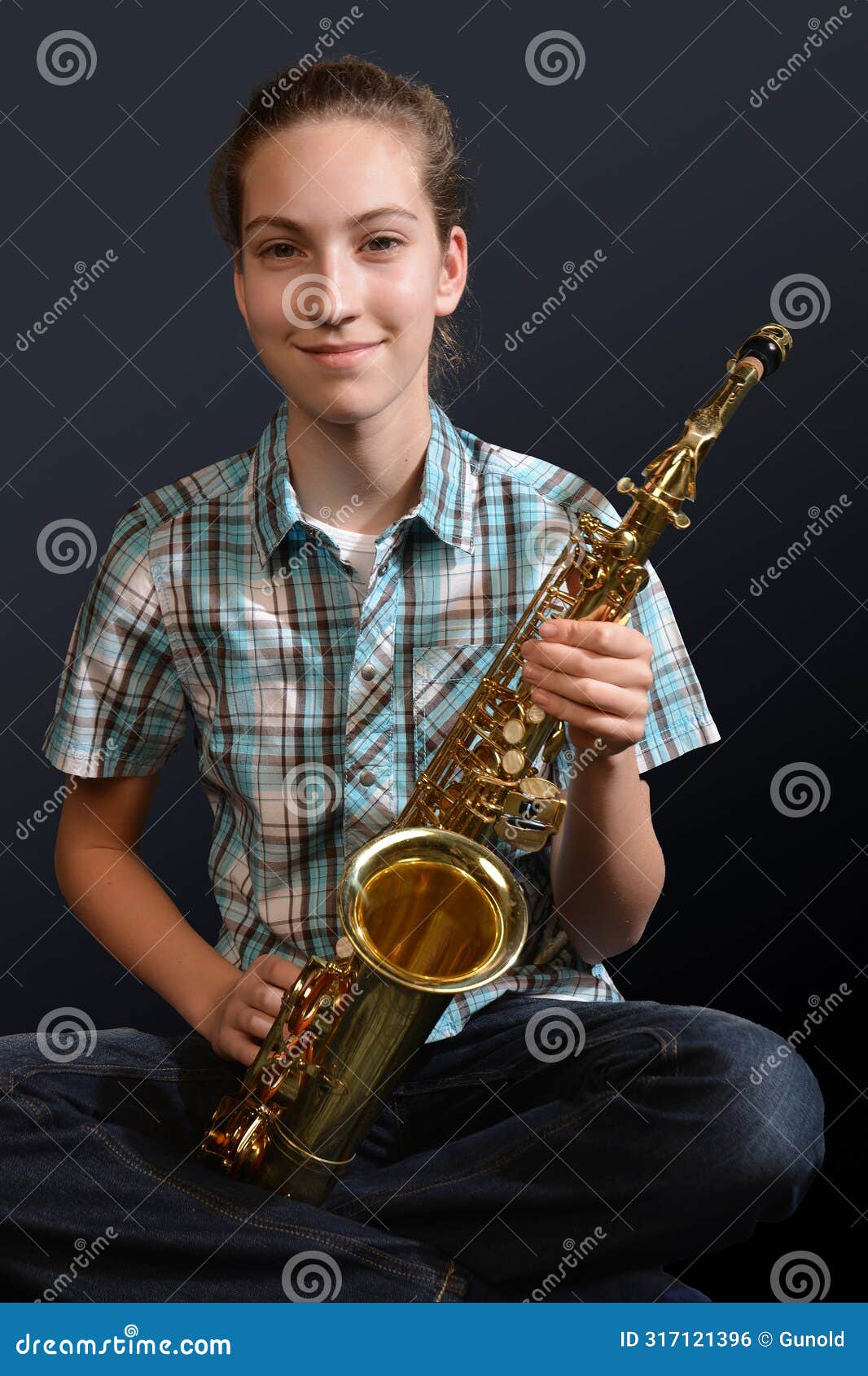 cute teenage girl practicing saxophone