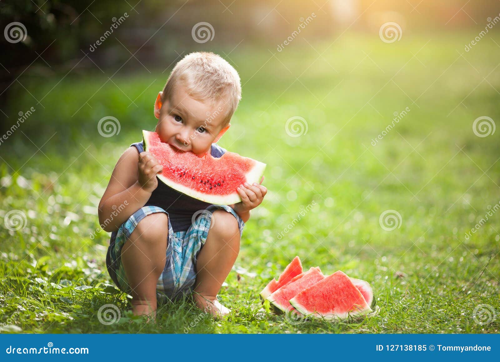 cute toddler eating a slice of watermelon