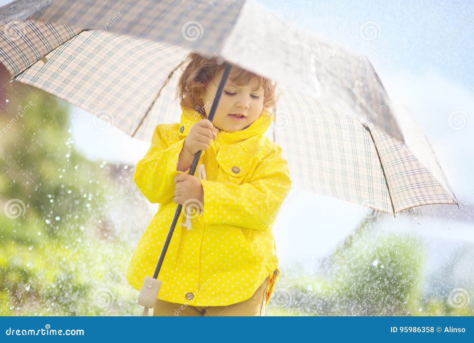 Cute Toddler Girl Wearing Yellow Waterproof Coat and Boots with Stock ...