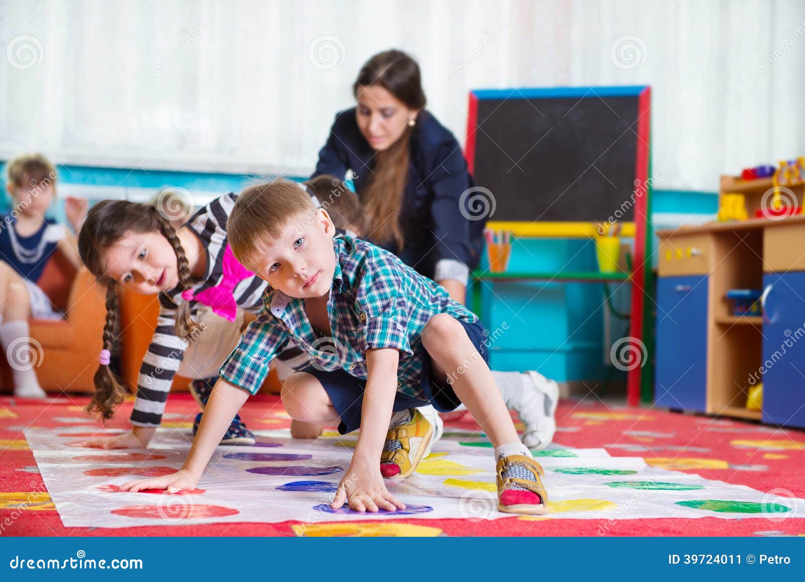 cute toddlers playing in twister game