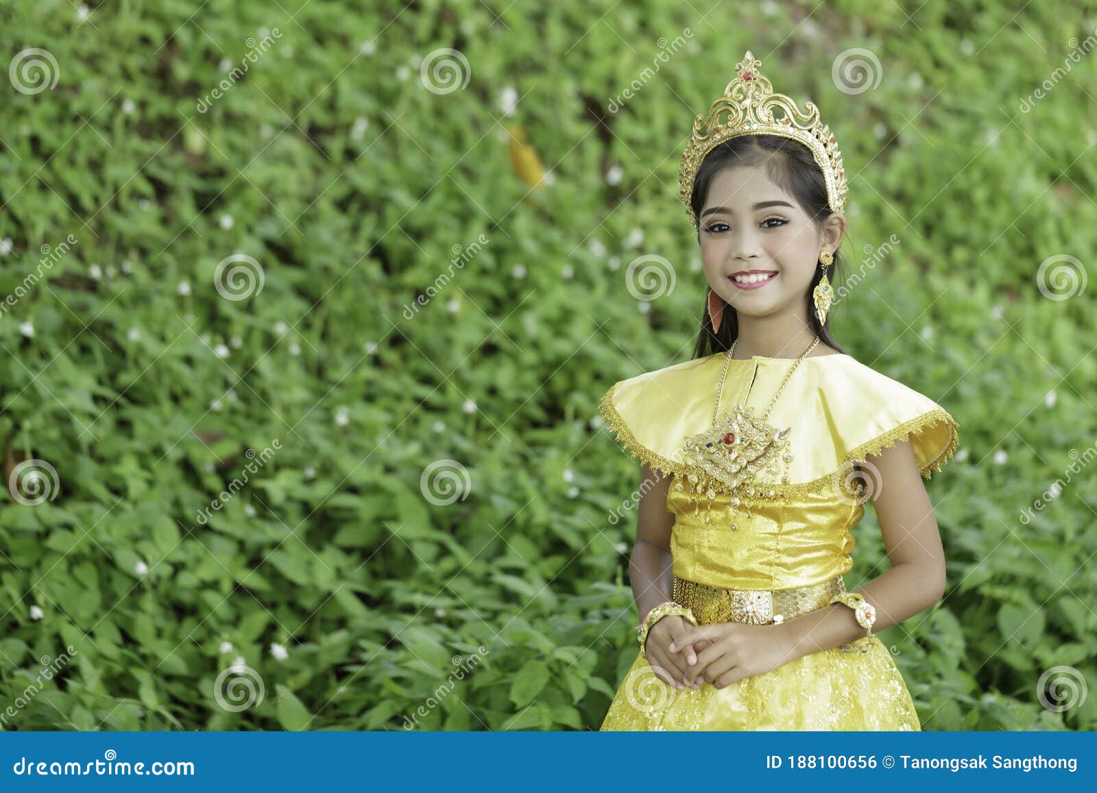 A Cute Young Asian Elementary School Student Wore a Golden Traditional ...