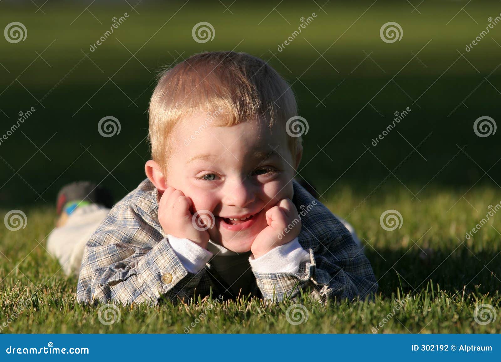 cute young boy with cheeky grin