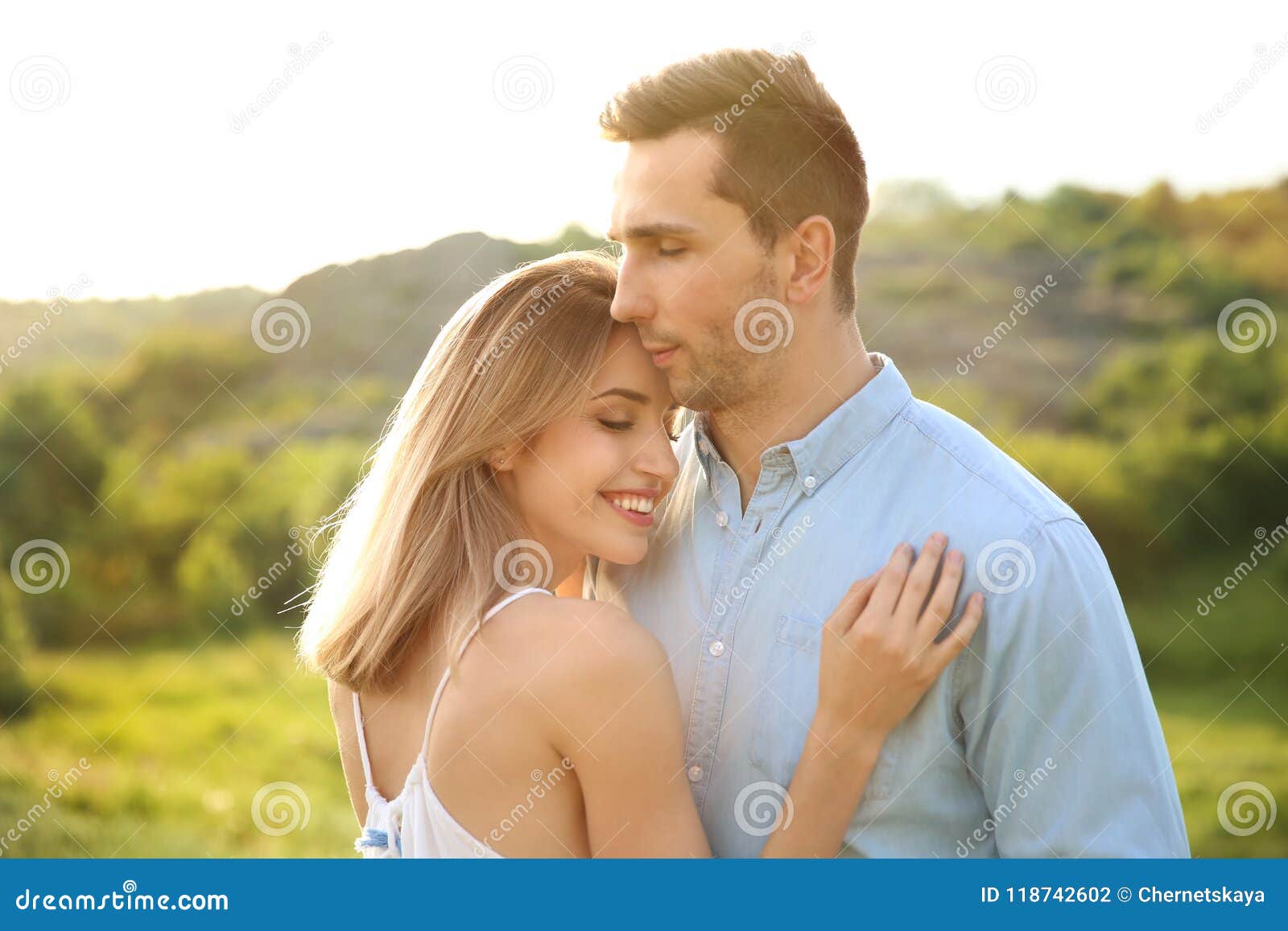 Cute Young Couple Posing Outdoors On Sunny Day Stock Photo Image