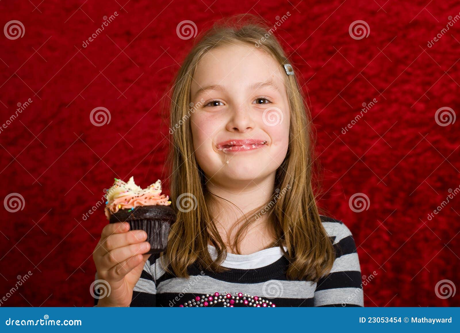 Cute Young Girl Eating a Cupcake Stock Photo Image of bite, happy 23053454