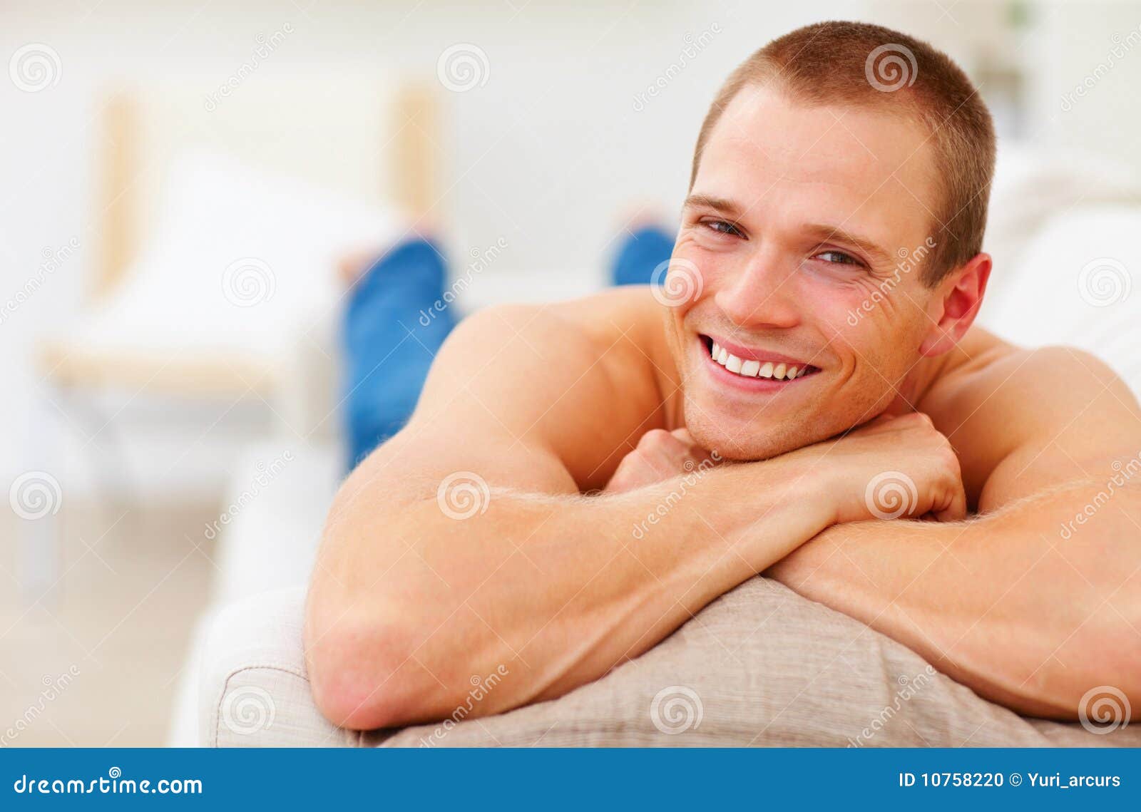 Cute Young Guy Relaxing on the Couch, Smiling Stock Photo Image of
