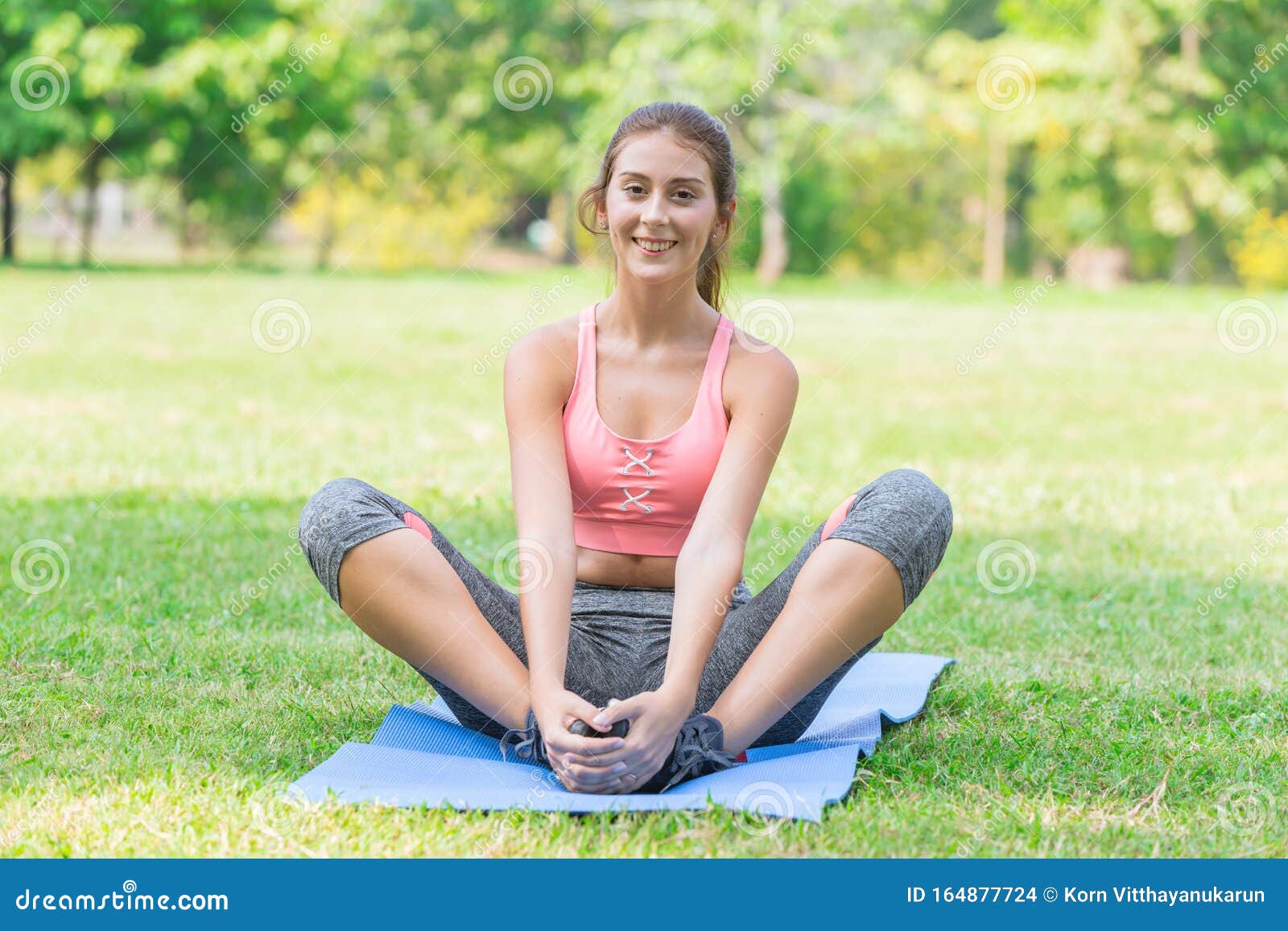 Cute Young Healthy Sport Teen Sitting Smiling on Yoga Mat Outdoor