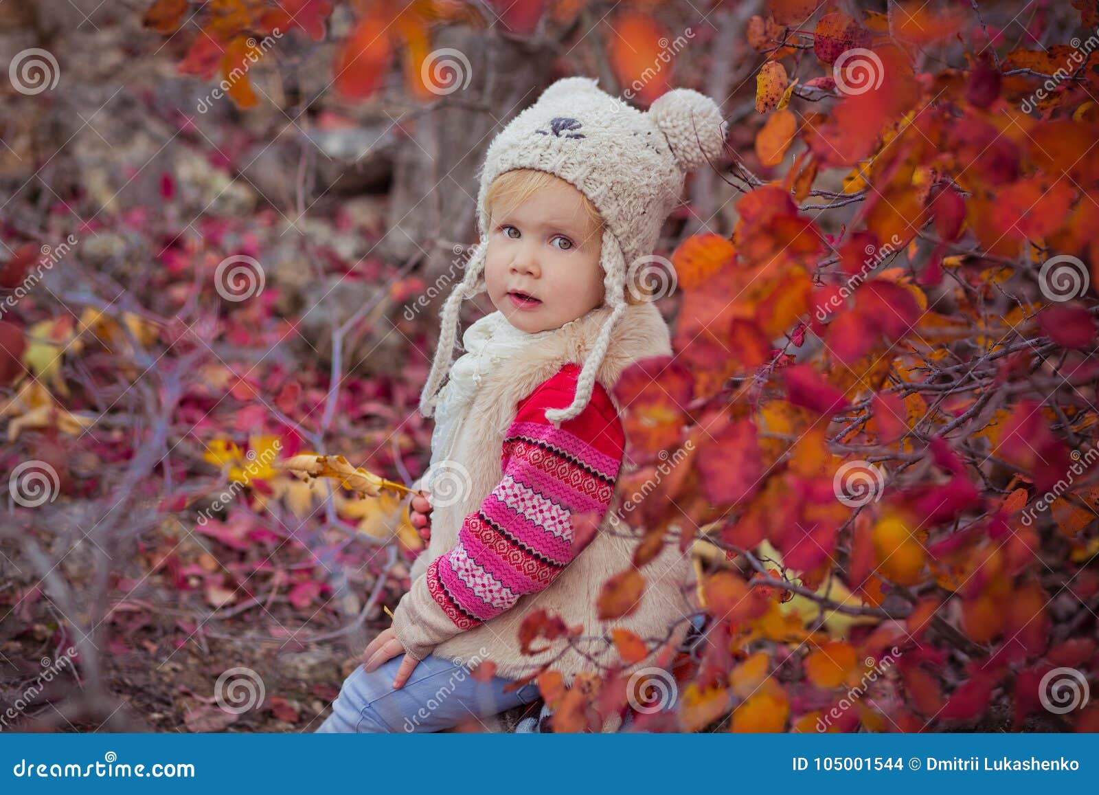 cute young russian baby girl stylish dressed in warm white fur handmade jacket blue jeans boots and hooked hat teddy bear posing i
