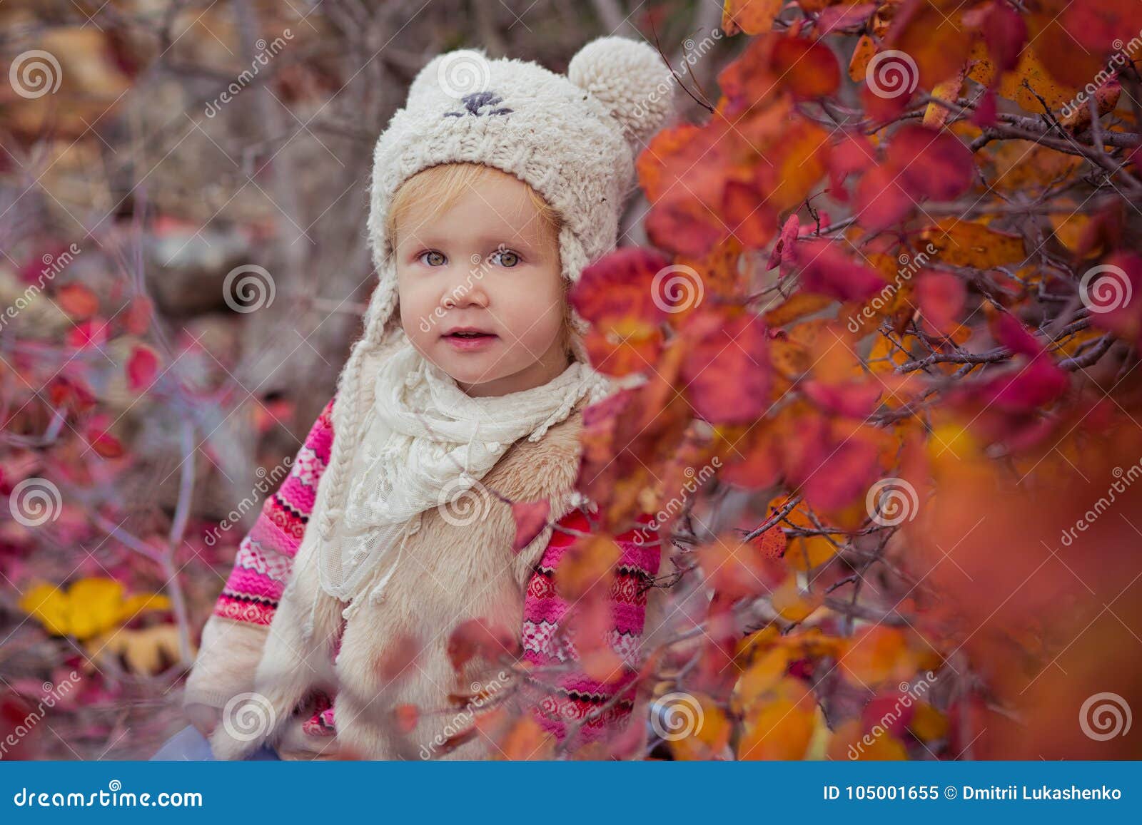 cute young russian baby girl stylish dressed in warm white fur handmade jacket blue jeans boots and hooked hat teddy bear posing i