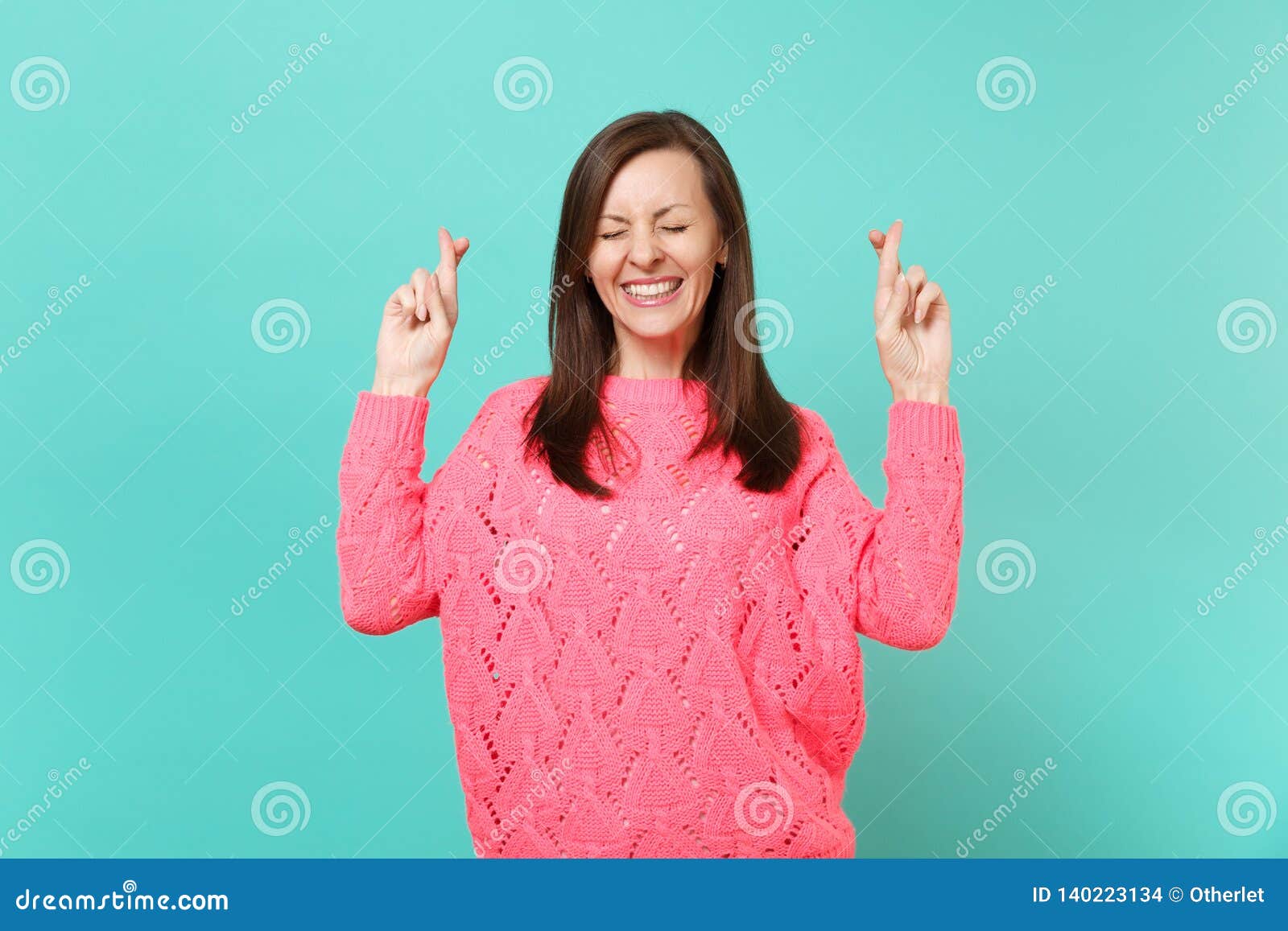 Cute Young Woman in Knitted Pink Sweater Keeping Fingers Crossed Eyes ...