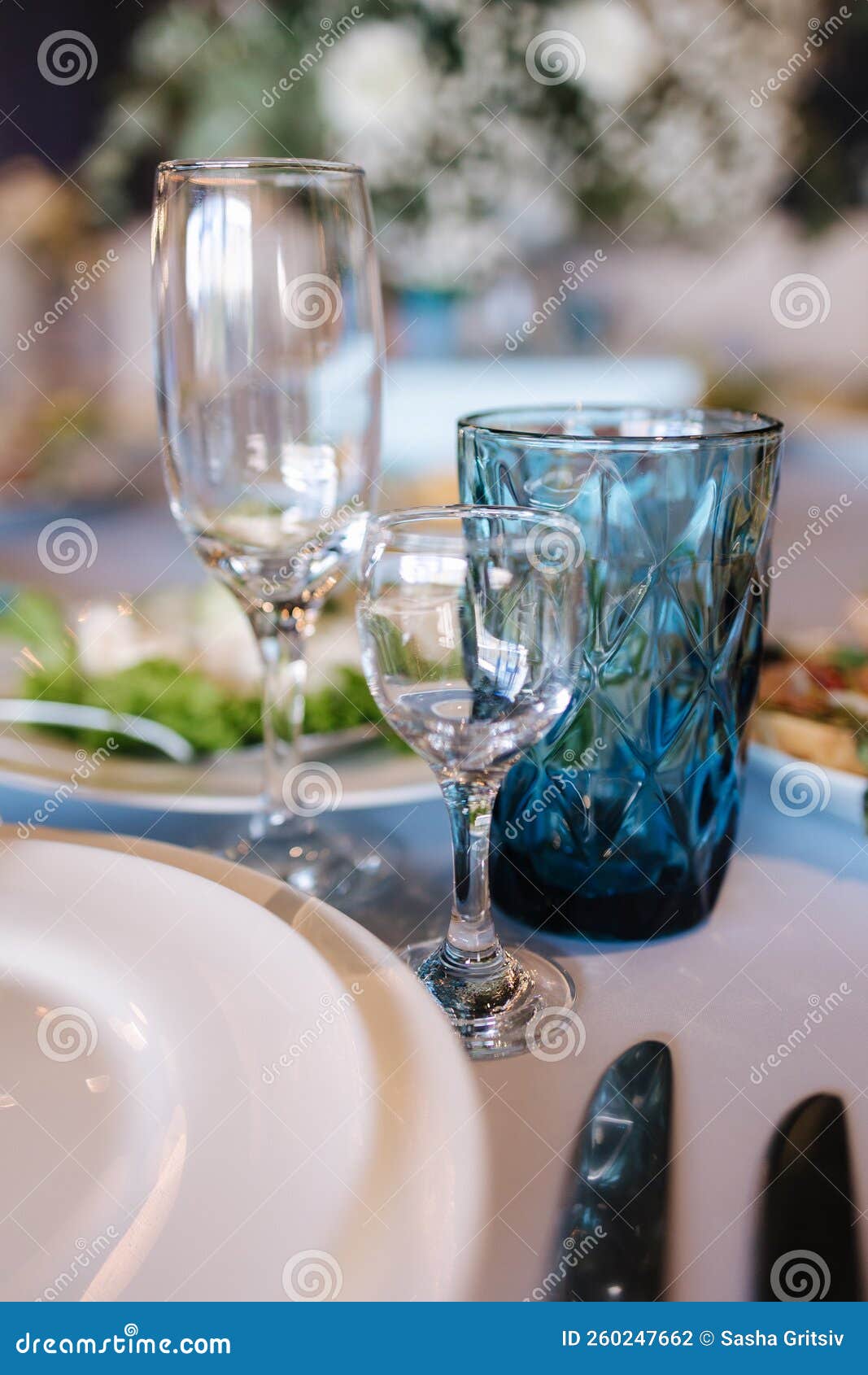 Cutlery and Glasses on the Table. Blue Elements of Decor Using in