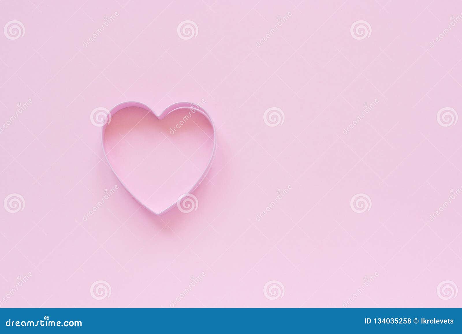 cutter cookies in heart  on pastel pink background. concept valentine`s card. top view copy space for text