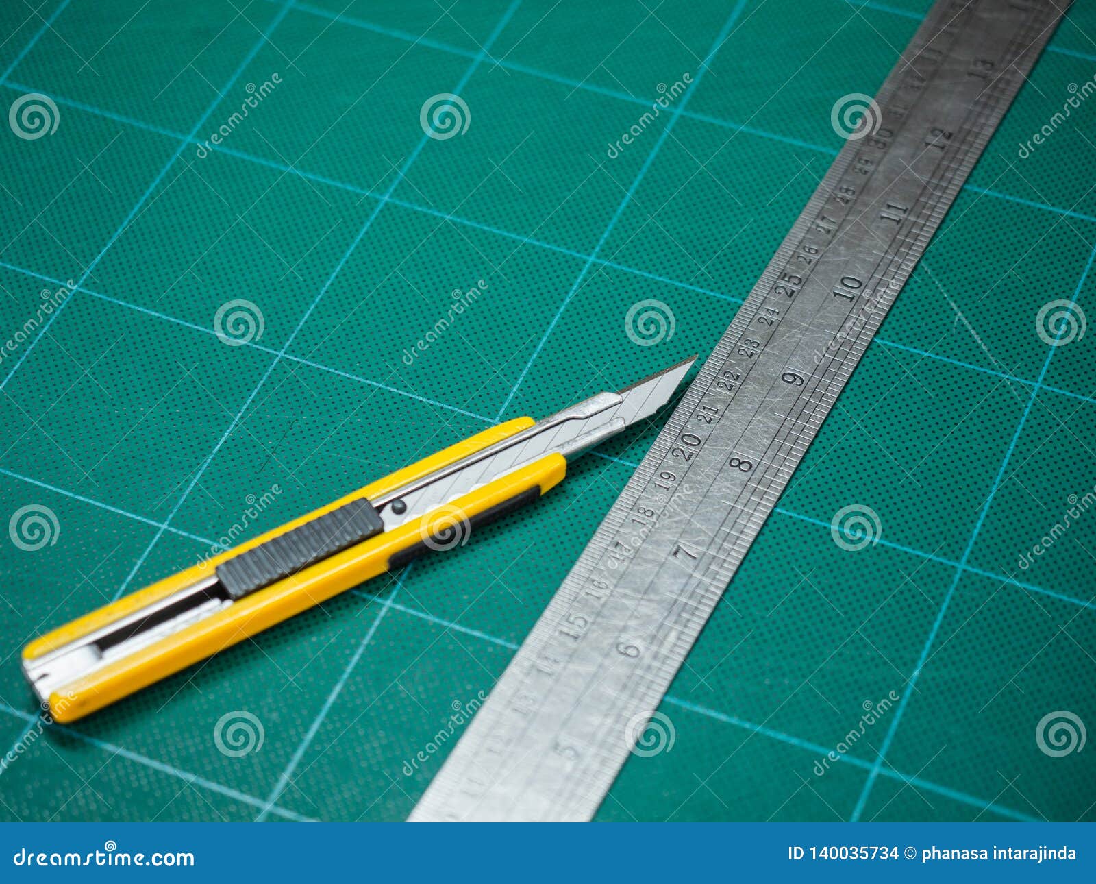 Cutter and Iron Ruler Isolated on a Cutting Mat Stock Photo Image of