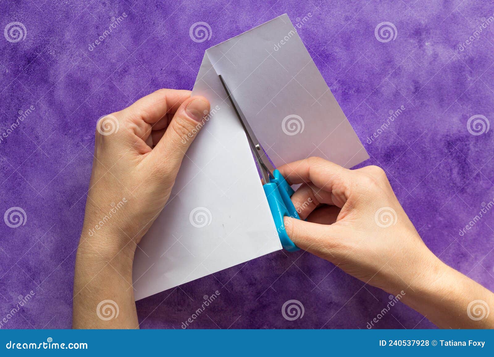 Kid,Hands,Cutting,Light,Blue,Colored,Paper,With,Scissors