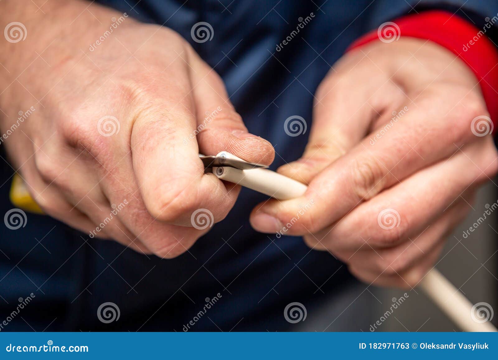 Cutting Cable Insulation with a Segmented Knife. White Cable, Yellow