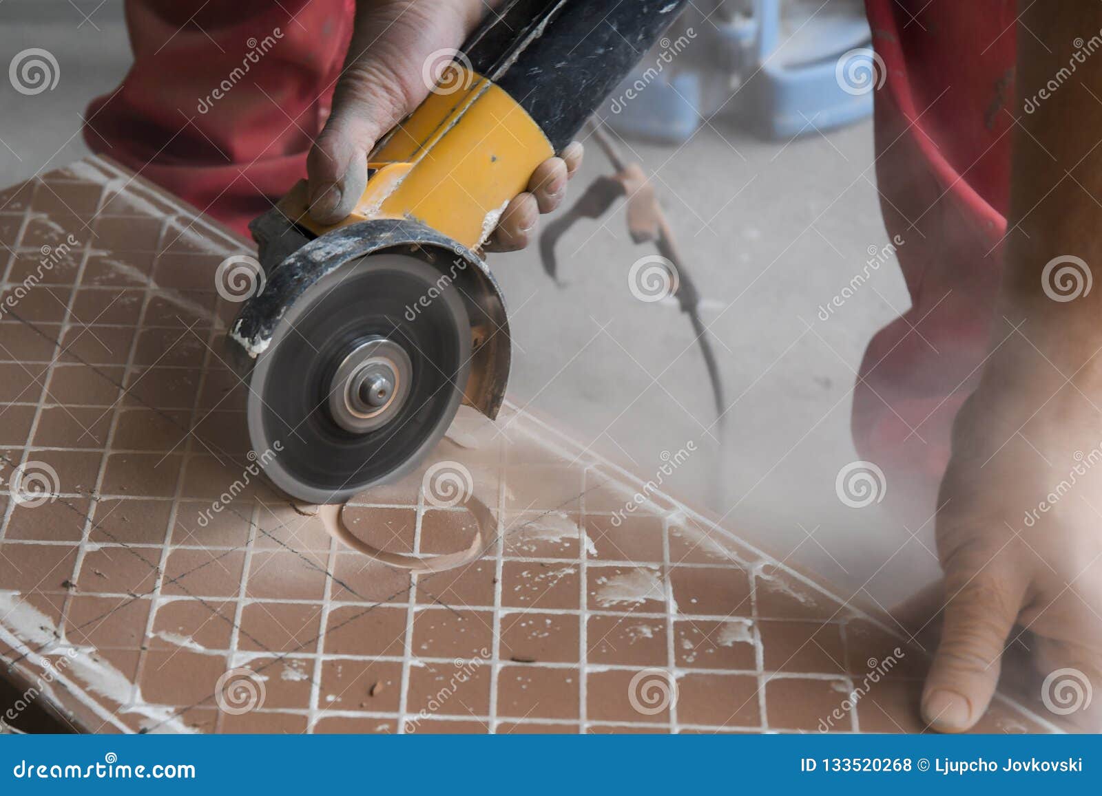 Worker Places New Tile On A Floor. Tiles Are Prepared For Use As Paving