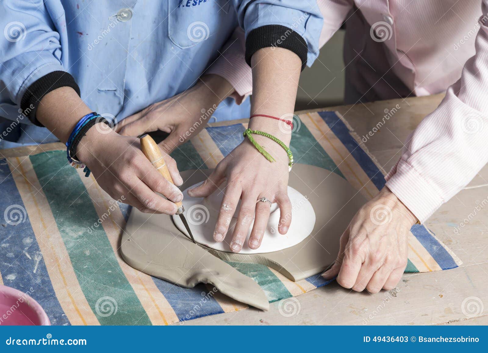 Cutting the clay to shape stock image. Image of skill 49436403