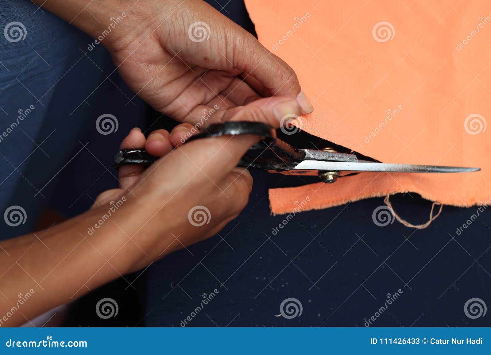 Cutting cloth, version stock image. Image of hands, knife 111426433