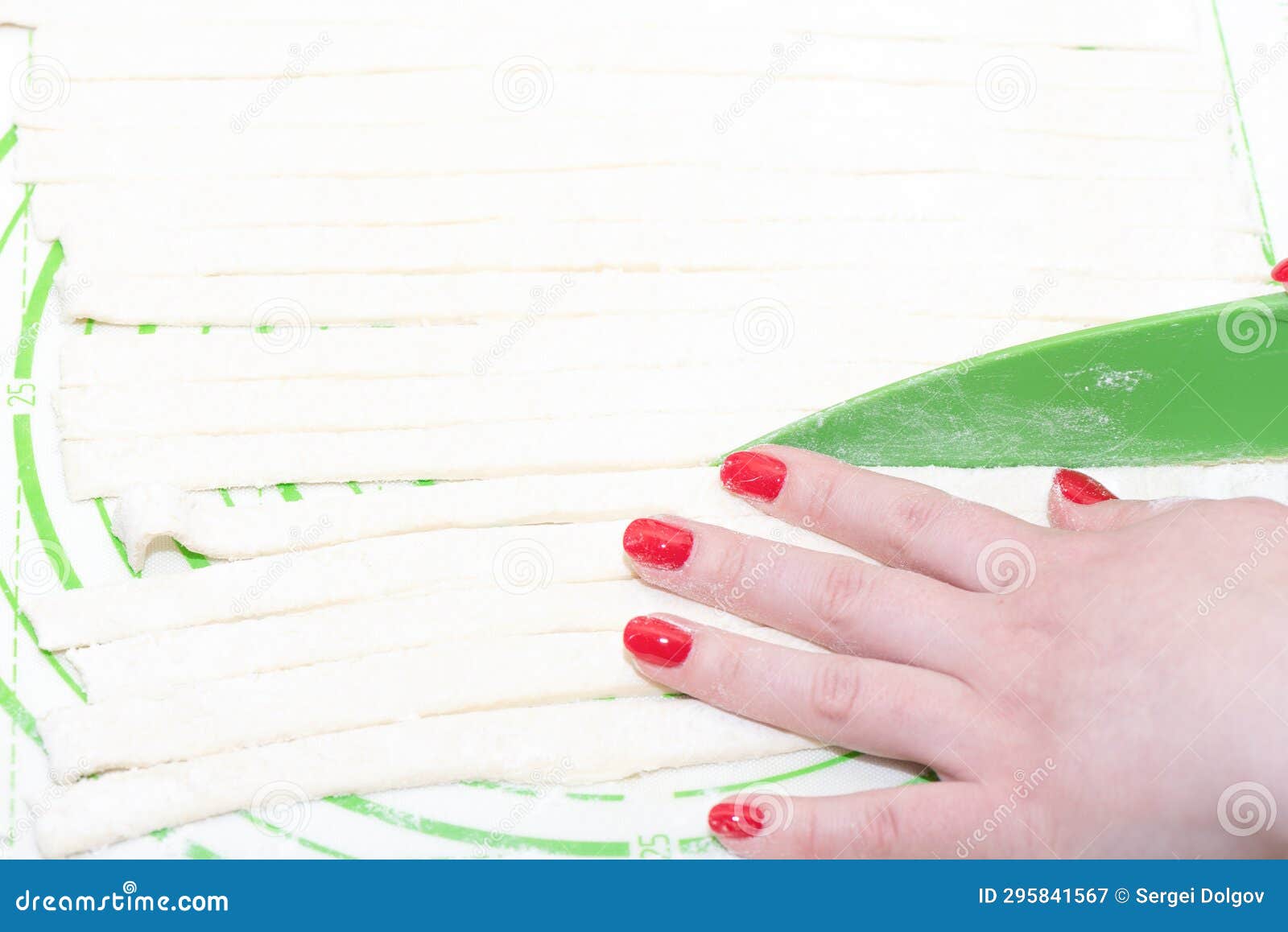 Cutting the Dough into Strips for Wrapping Sausages. Stock Image