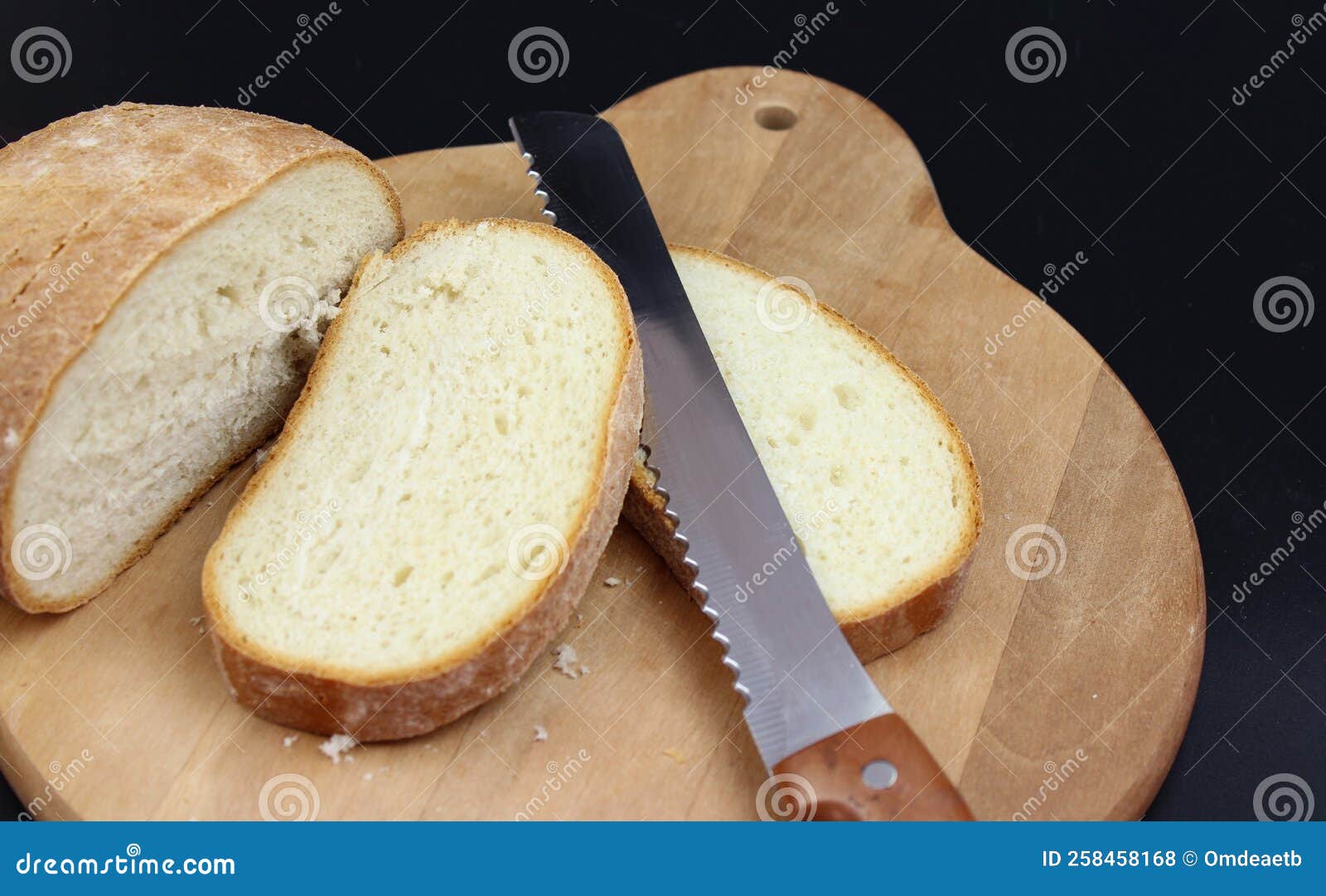 Cutting Loaf of Bread with Knife on Cutting Board Stock Photo Image