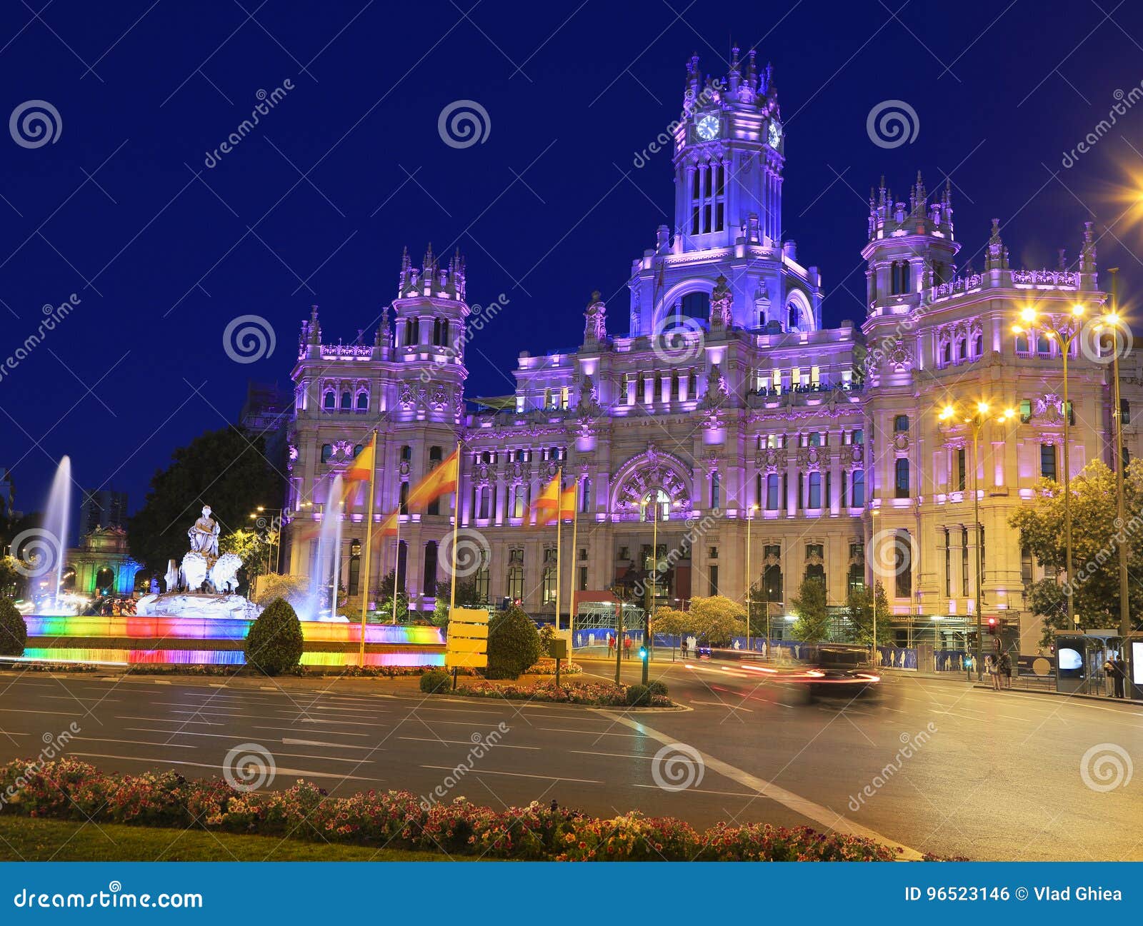the cybele palace and fountain illuminated at night in madrid, spain
