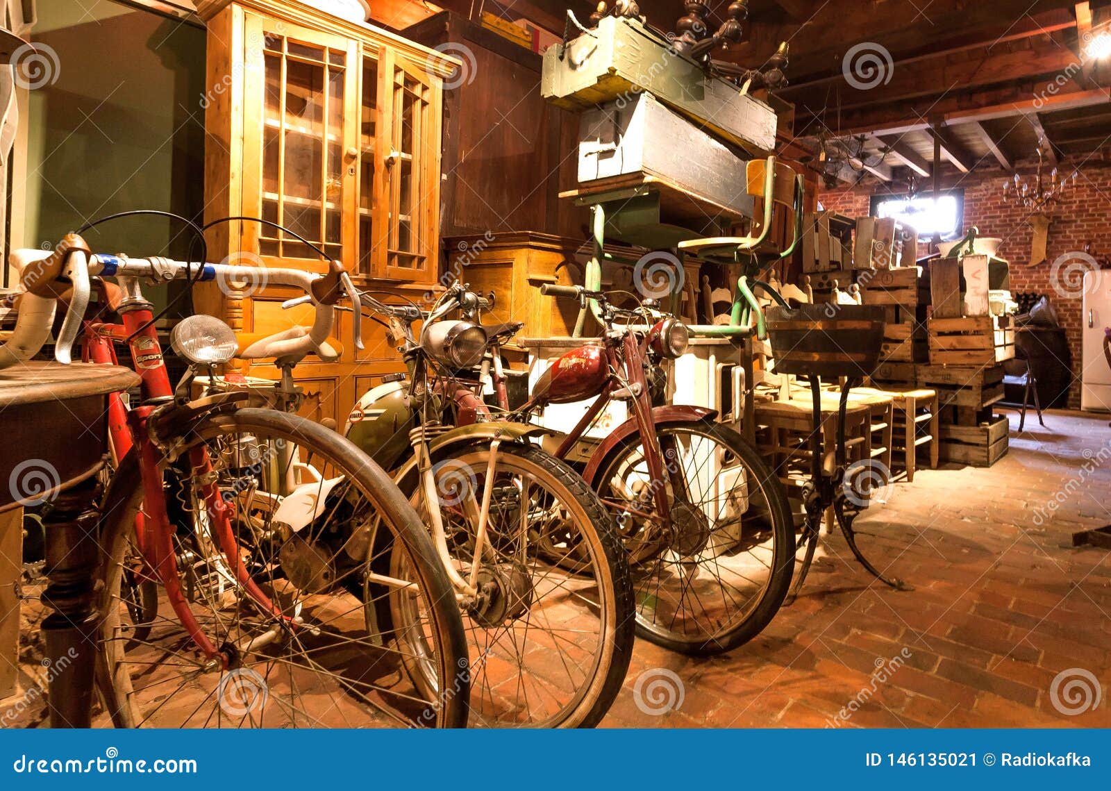 Cycles and Retro Bikes for Sale Inside Antique Store with Many Vintage Utensil, Decor, Wooden Furniture Editorial Photo