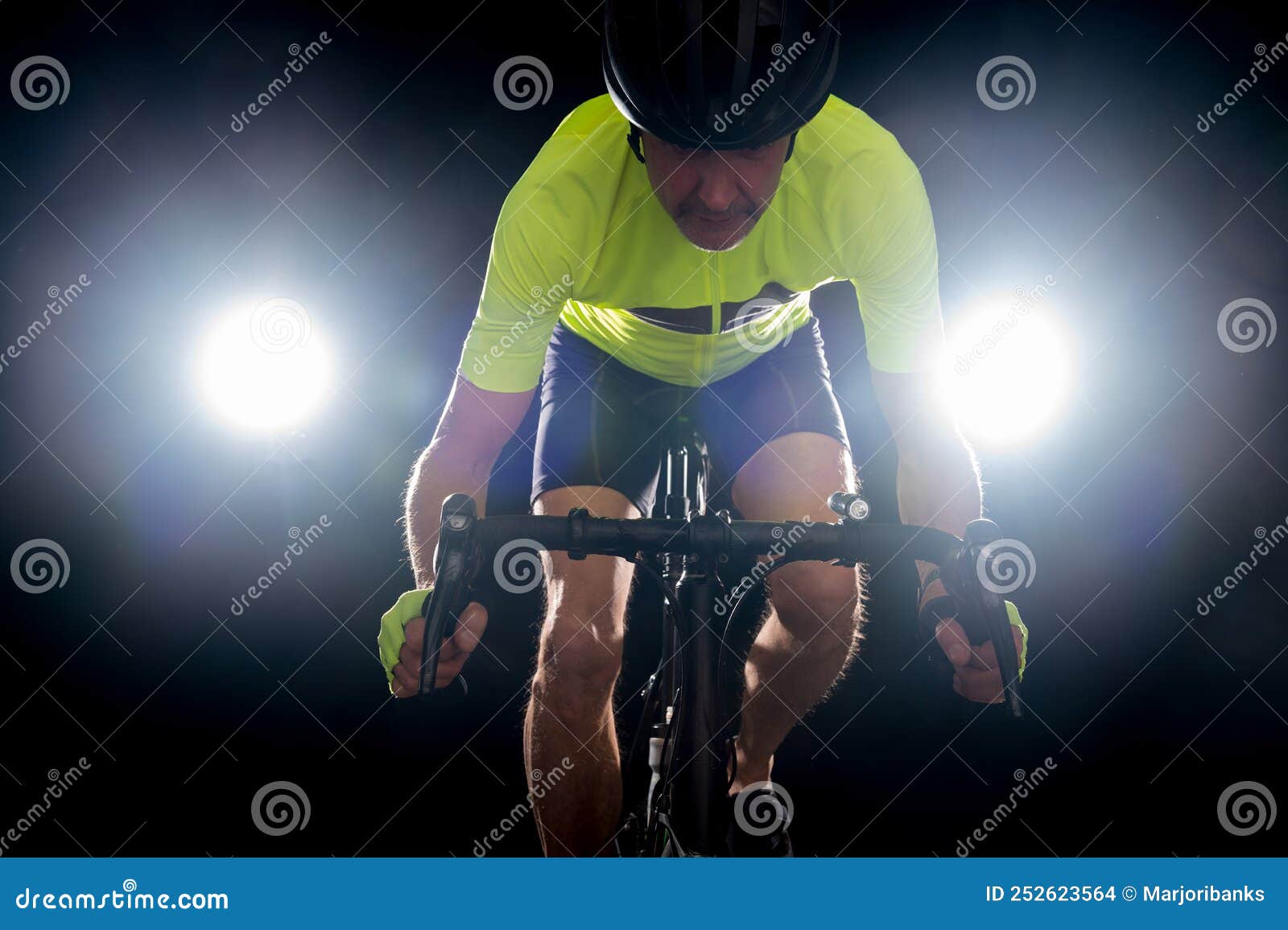 cyclist backlit on a black background. road safety tailgating concept