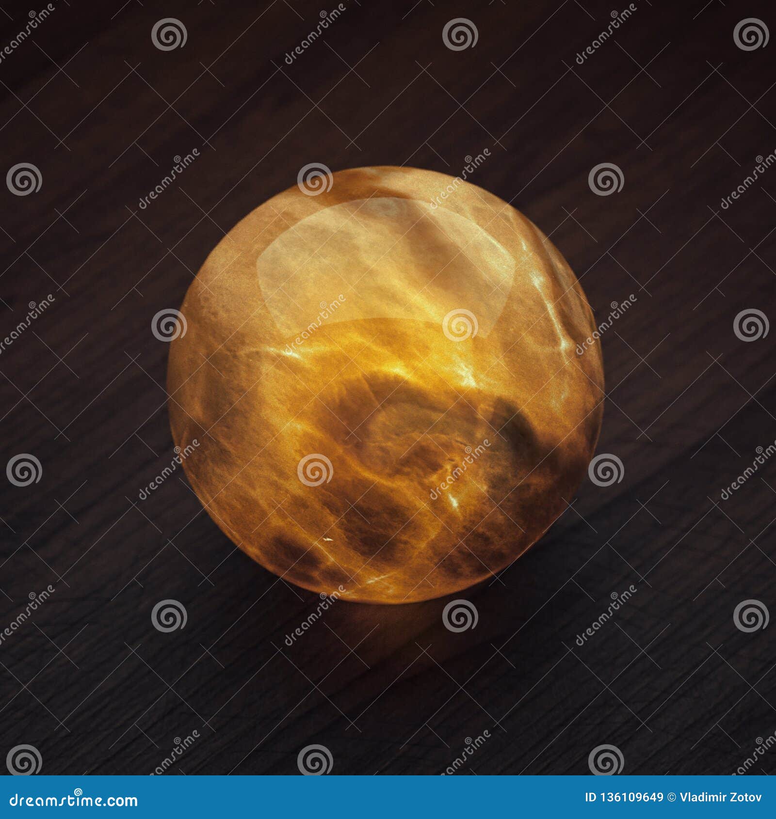 3d Illustration. Self Illuminated Red Onyx Ball on the Table. Stock