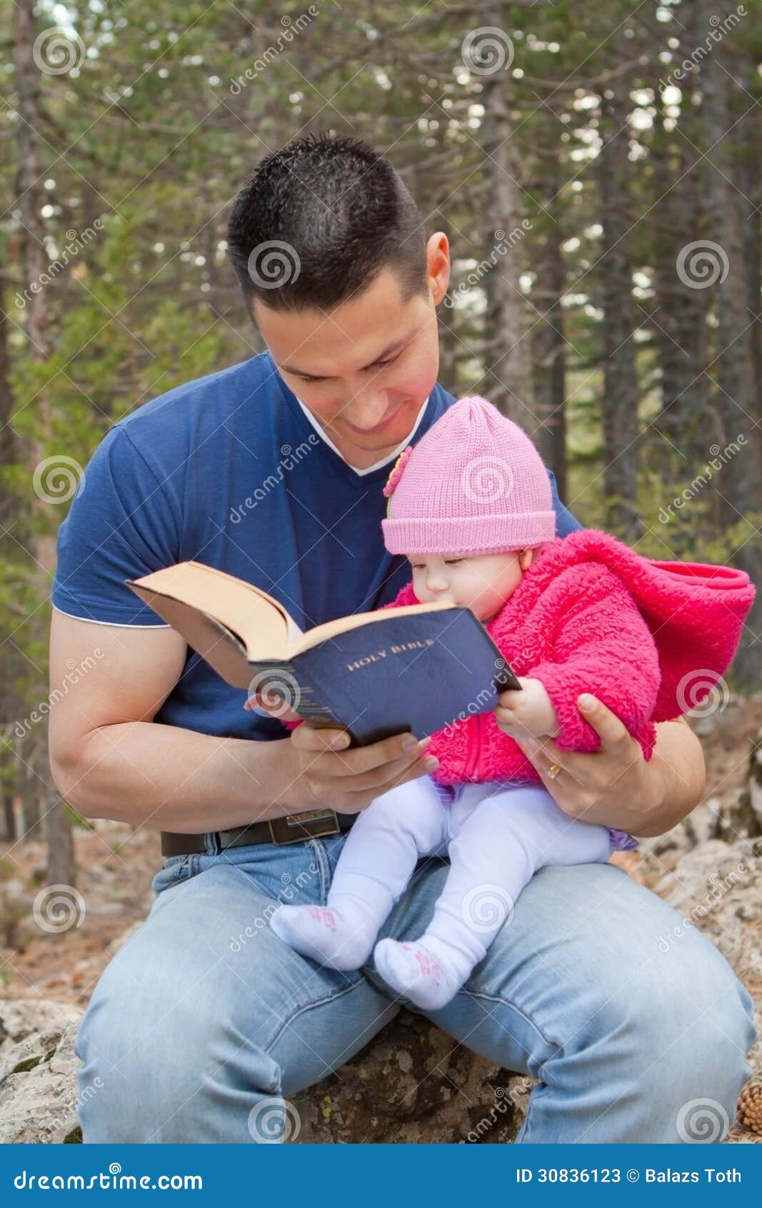dad and baby daughter reading bible