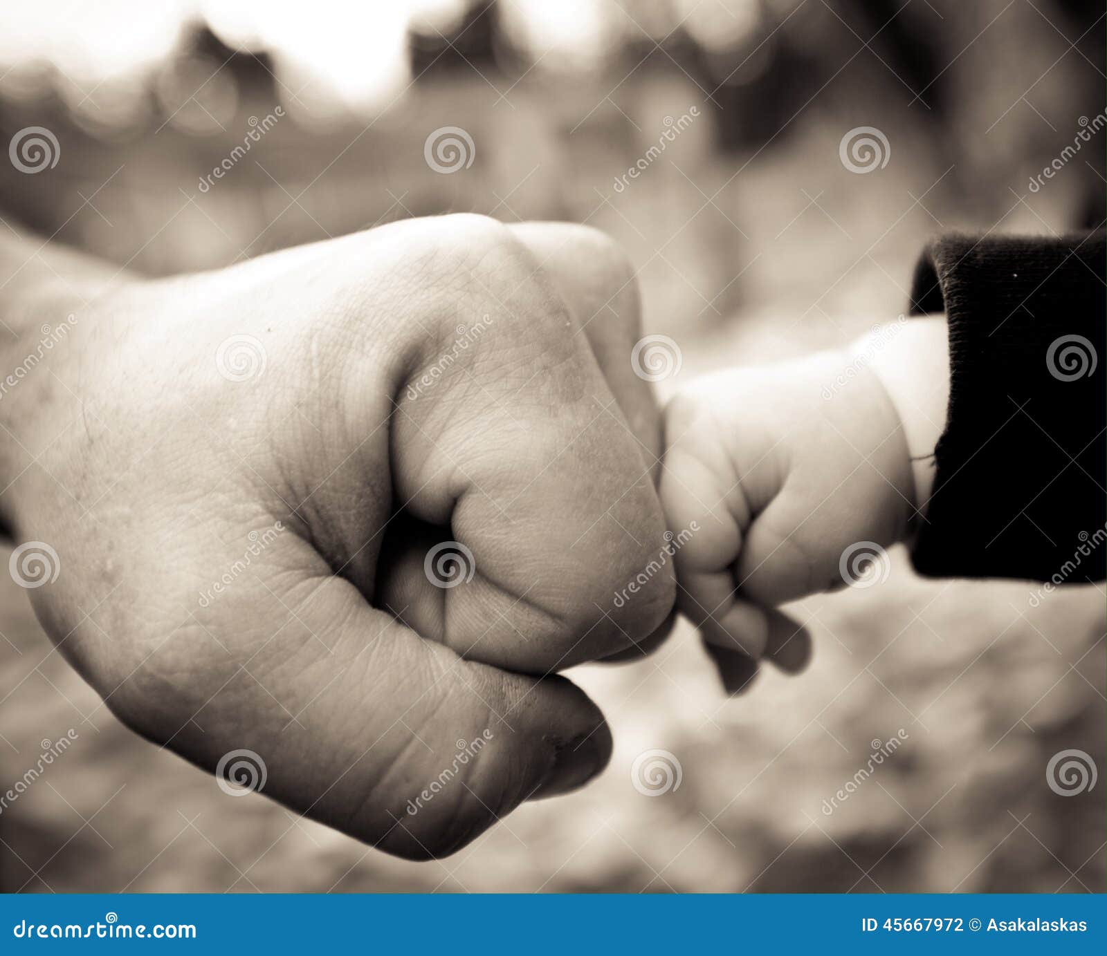 dad and baby fist bump