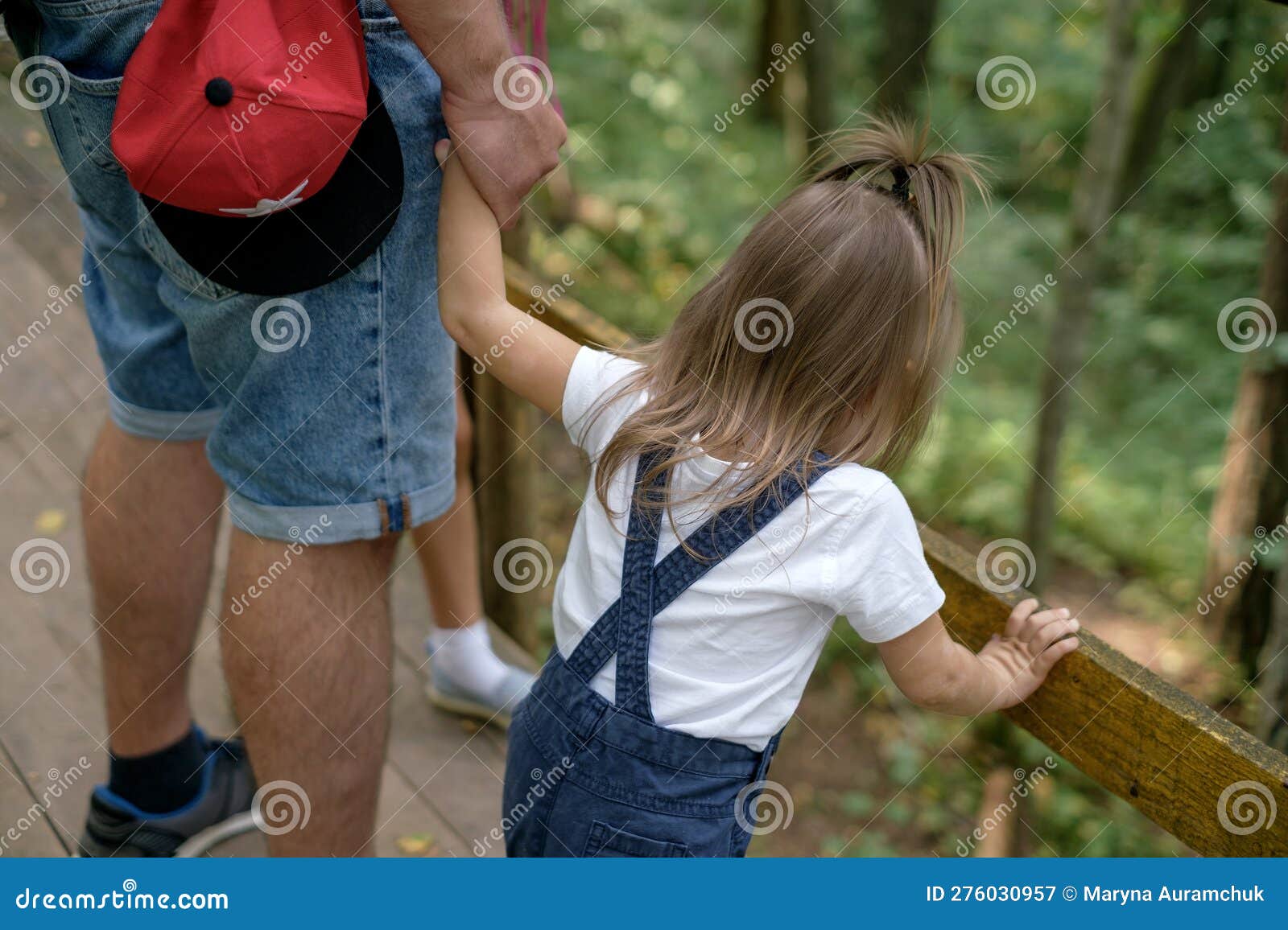 Dad Holds Little Daughter Tightly By Hand While Walking Through The Forests Stock Image Image