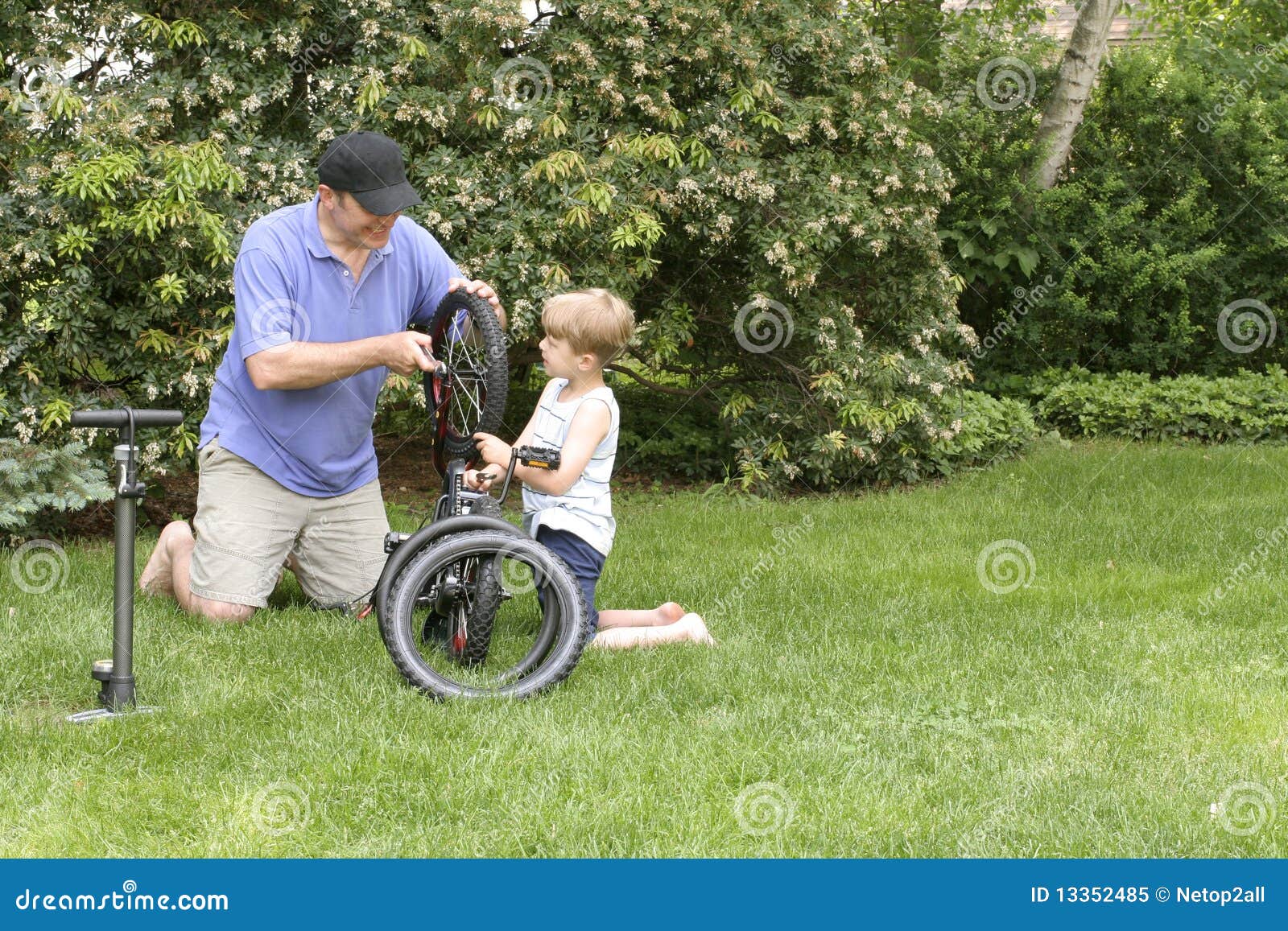 Download Dad And Son Fixing A Bike Royalty Free Stock Photo - Image ...