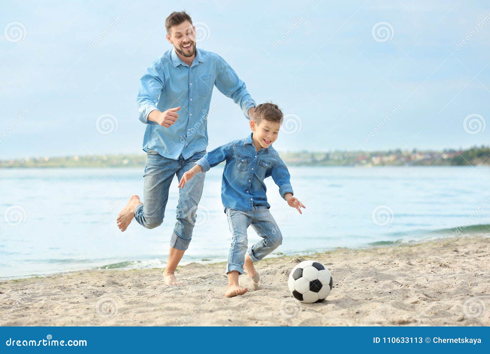Dad and Son Playing Football Together Stock Image - Image of male