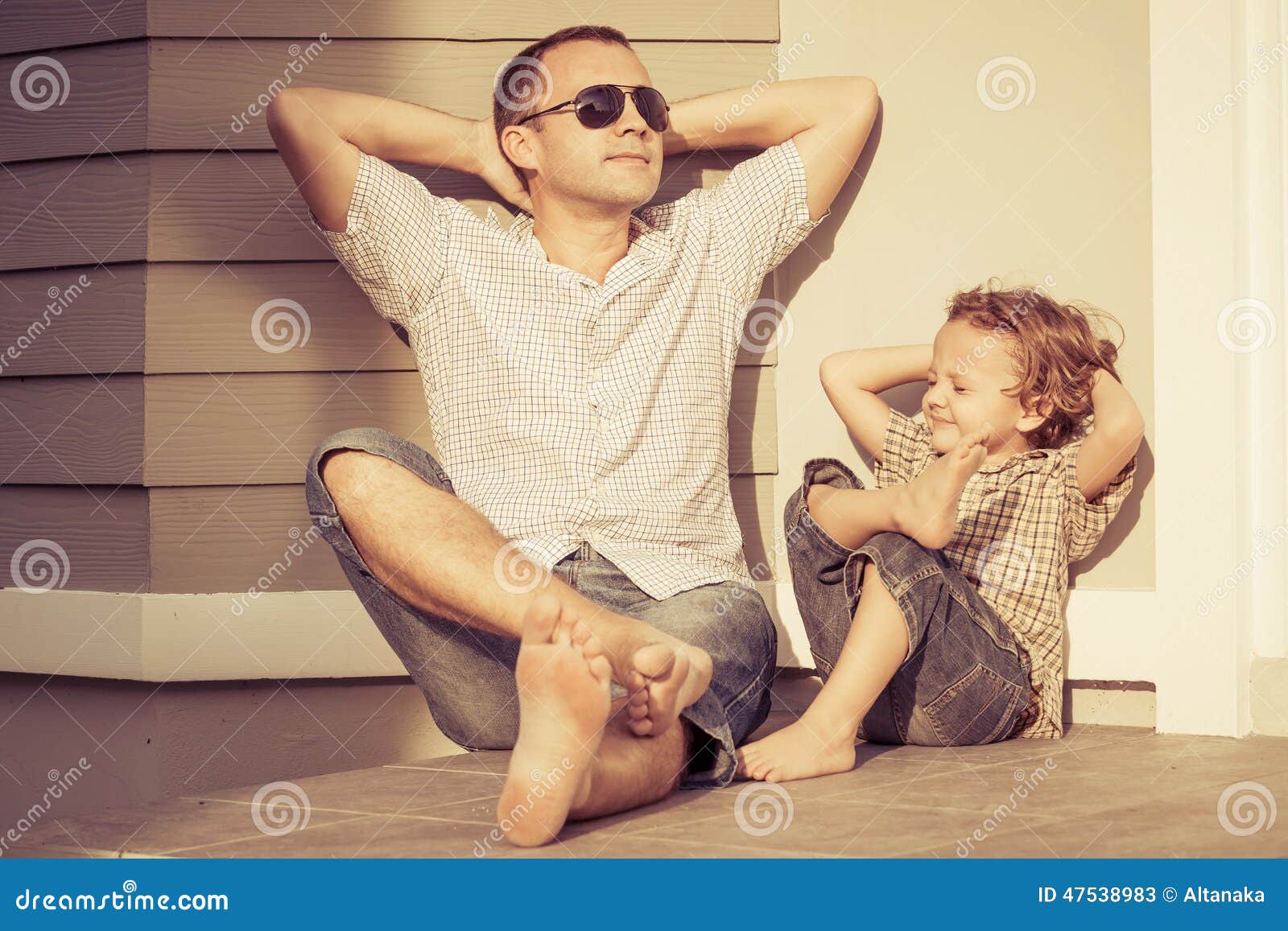 dad and son playing near a house