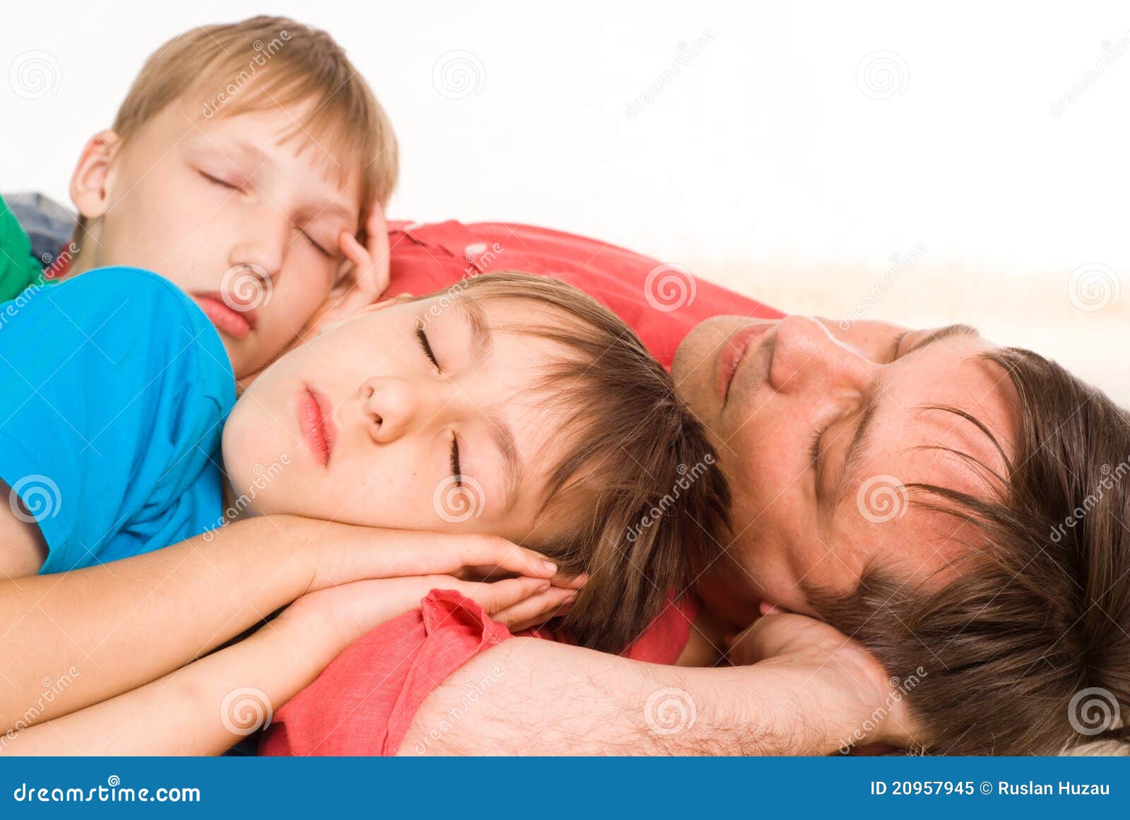 Dad and sons sleeping stock image