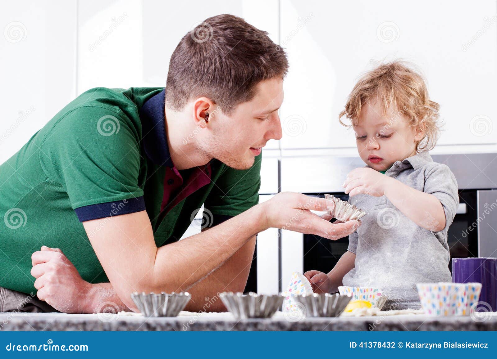 Dad Teaches Son Bake Muffins Stoc pic