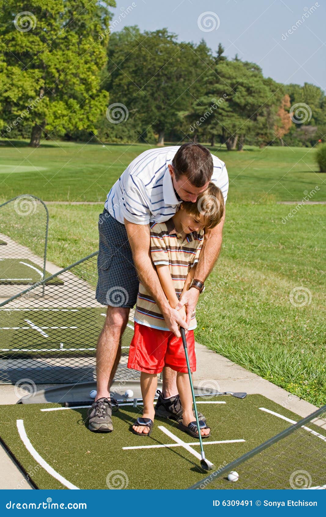 Dad Teaching Son Golf stock image. Image of family, hole 6309491