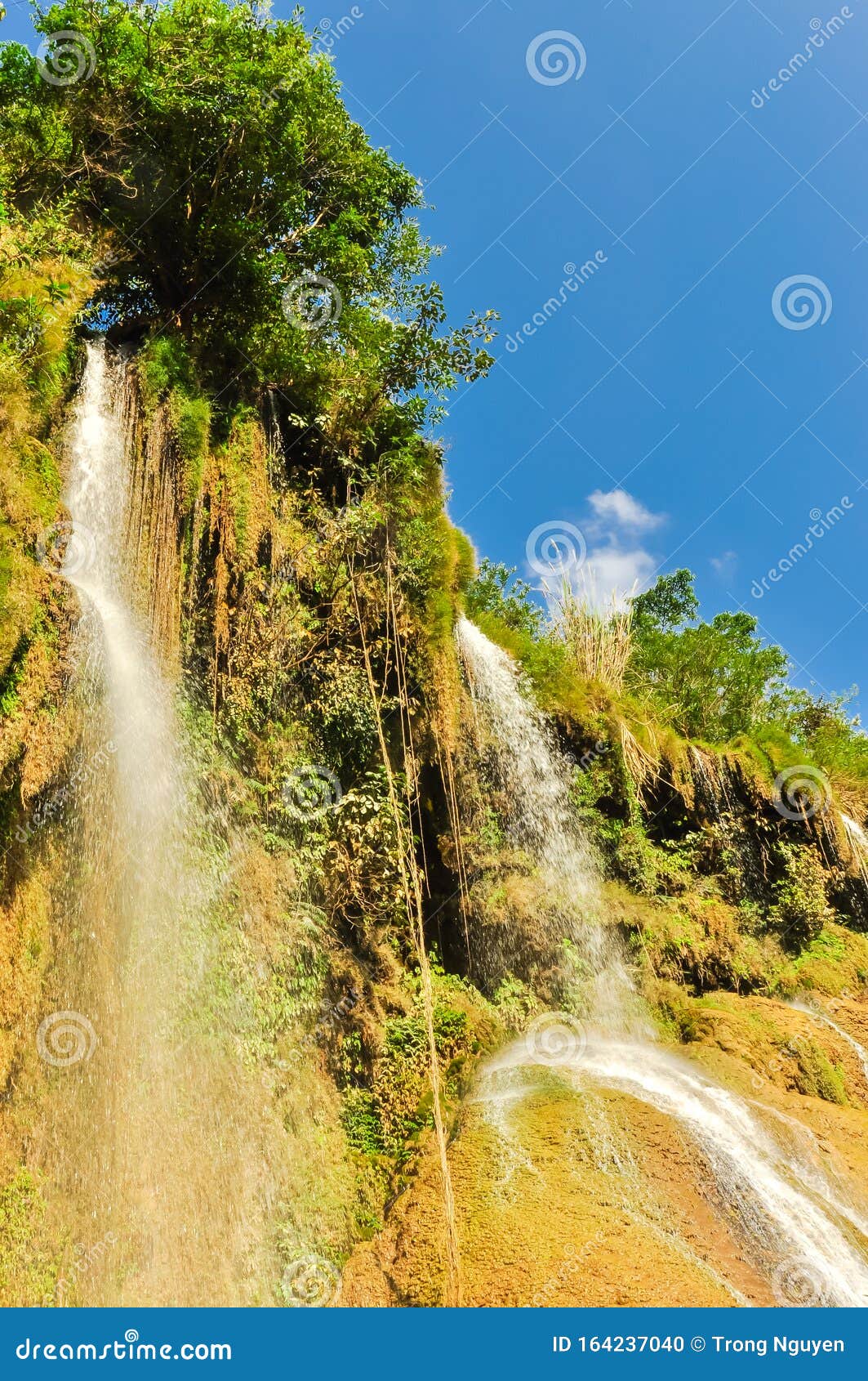 dai yem pink blouse waterfall cascades down the steep mountain slopes in son la, vietnam