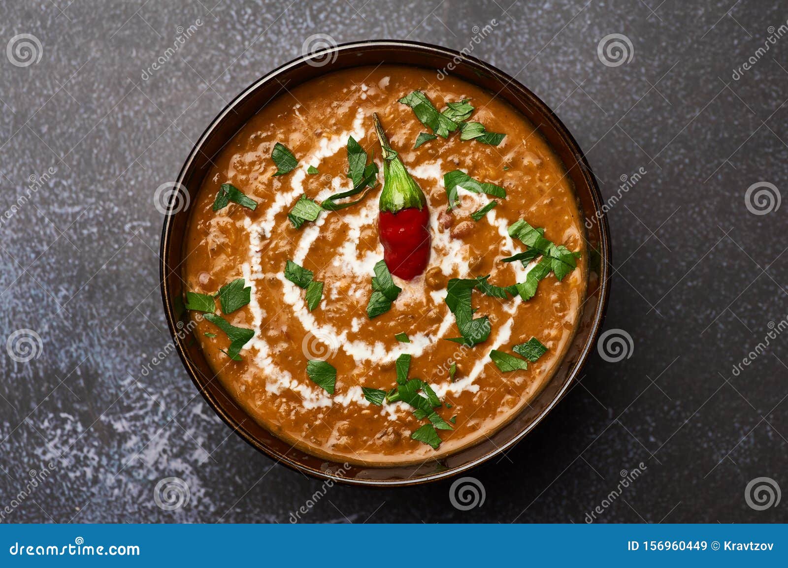 dal makhani at dark background. dal makhani - traditional indian cuisine puree dish with urad beans, red beans, butter, spices and