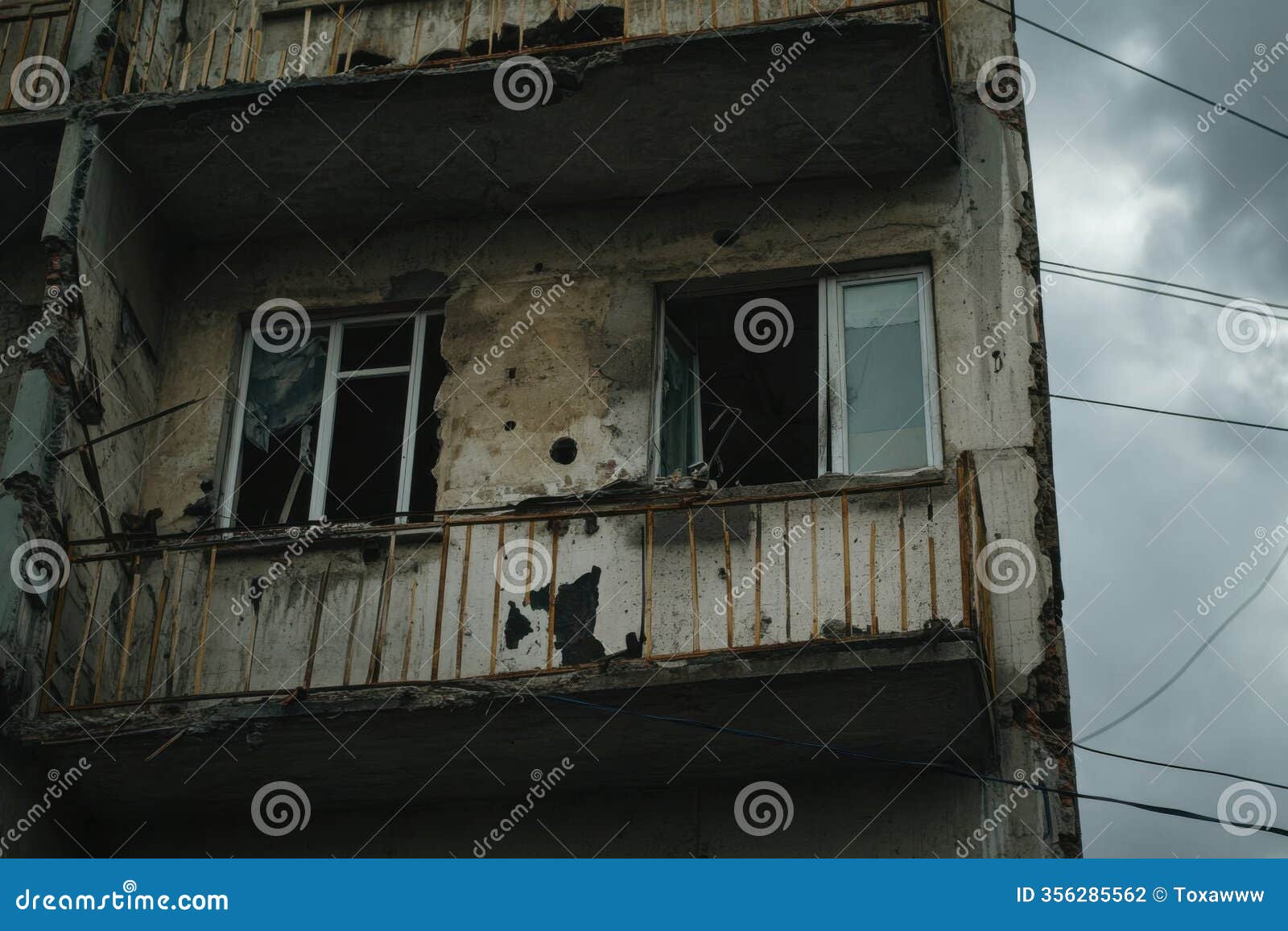 damaged apartment showing broken windows and weathered walls in overcast light