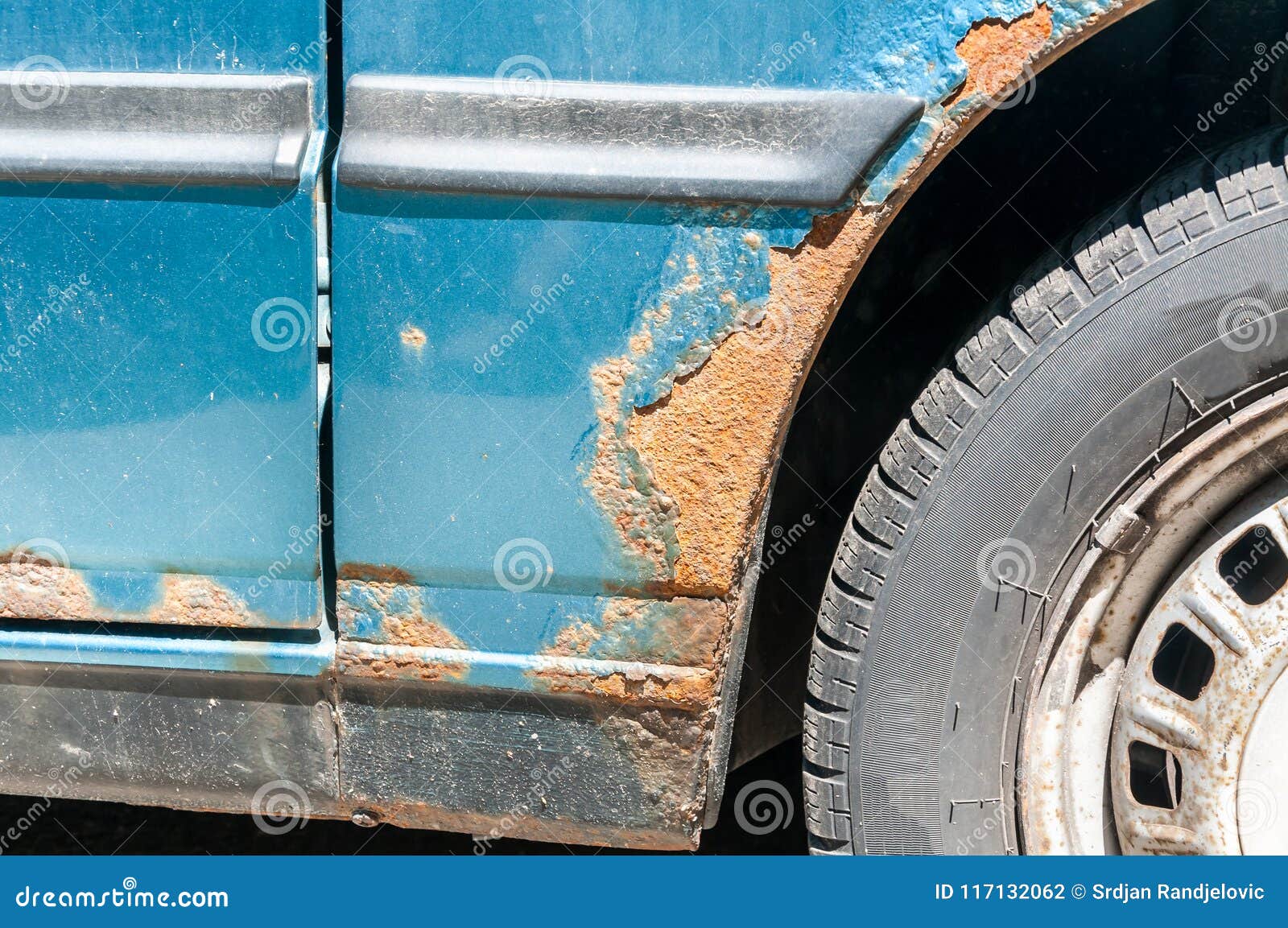 Damaged Corroded Blue Car with Scratched Paint and Rust Close Up Stock